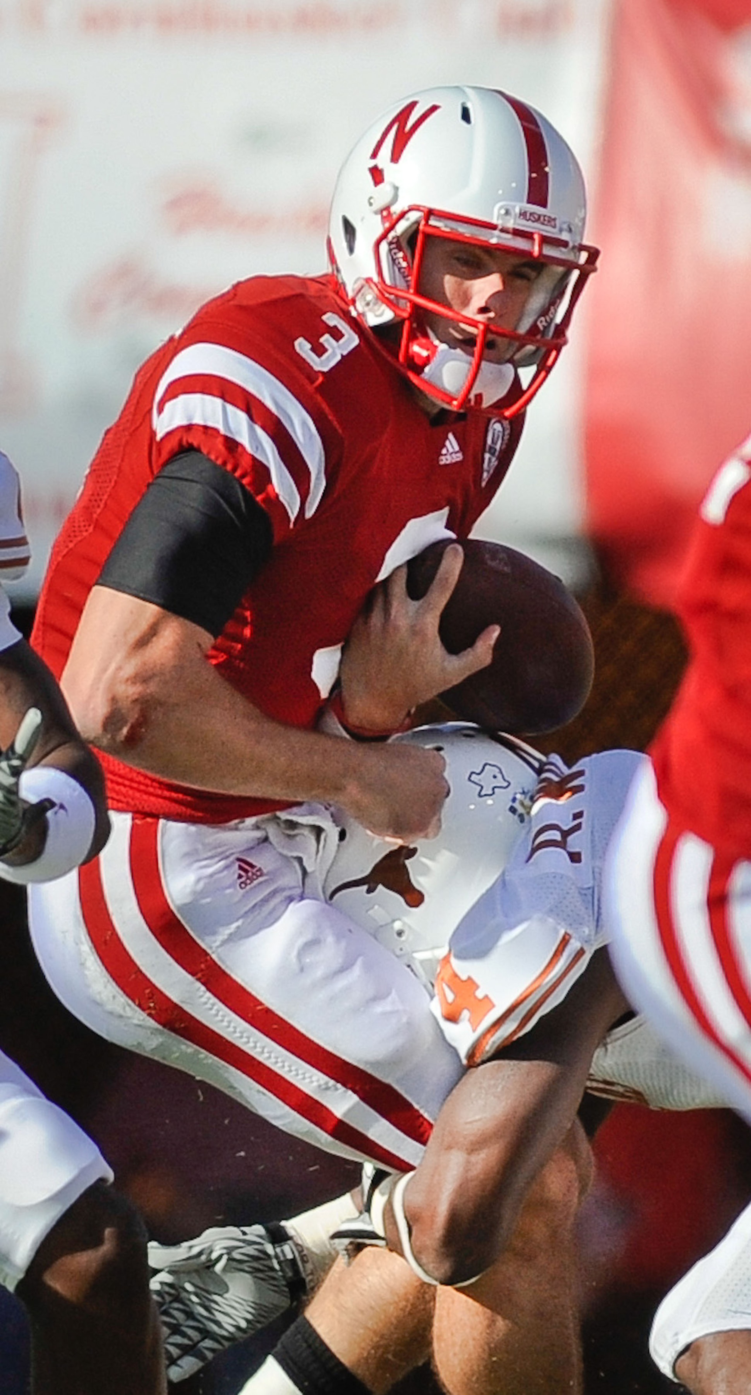 LINCOLN, NE - OCTOBER 16: Quarterback Taylor Martinez #3 of the Nebraska Cornhuskers gets the ball knocked loose by cornerback Aaron Williams #4 of the Texas Longhorns during their game at Memorial Stadium on October 16, 2010 in Lincoln, Nebraska. Texas D