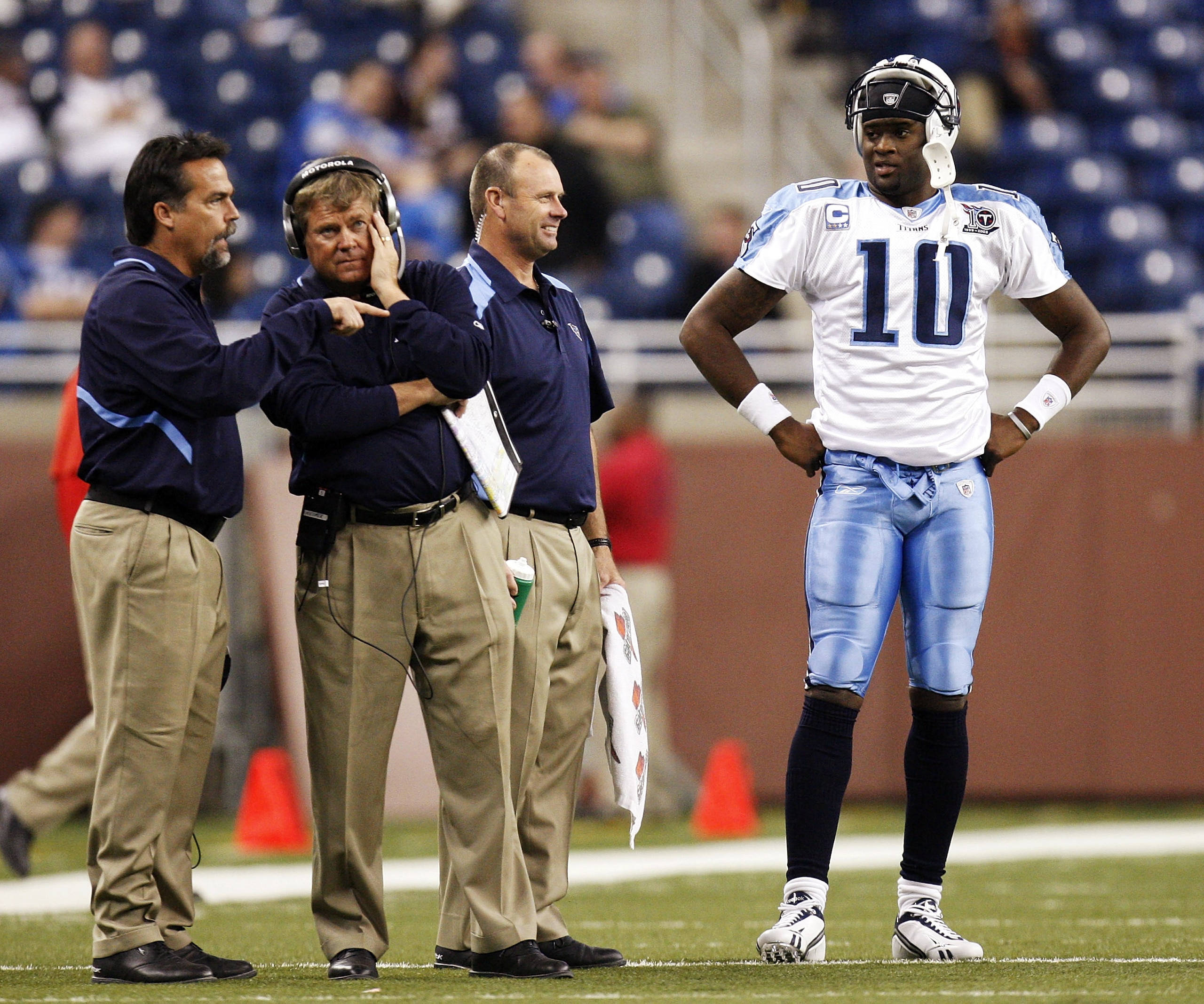 DETROIT , MI - NOVEMBER 27: Vince Young #10 of the Tennessee Titans talks with head coach Jeff Fisher, offensive coordinator Mike Heimerdinger and trainer Brad Brown after coming in the game in the fourth quarter against the Detroit Lions on November 27,