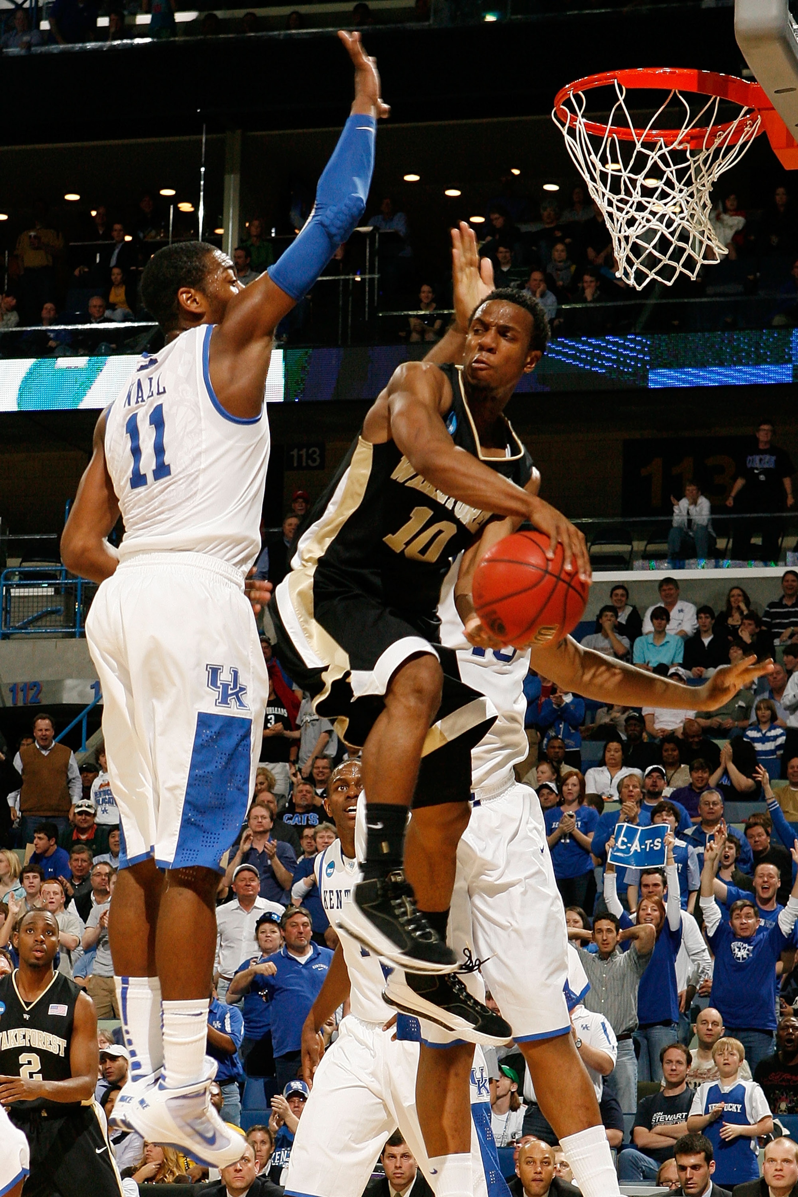 NEW ORLEANS - MARCH 20: Ishmael Smith #10 of the Wake Forest Demon Deacons passes the ball around John Wall #11 of the Kentucky Wildcats during the second round of the 2010 NCAA men's basketball tournament at the New Orleans Arena on March 20, 2010 in Ne NEW ORLEANS - MARCH 20: Ishmael Smith #10 of the Wake Forest Demon Deacons passes the ball around John Wall #11 of the Kentucky Wildcats during the second round of the 2010 NCAA men's basketball tournament at the New Orleans Arena on March 20, 2010 in Ne
