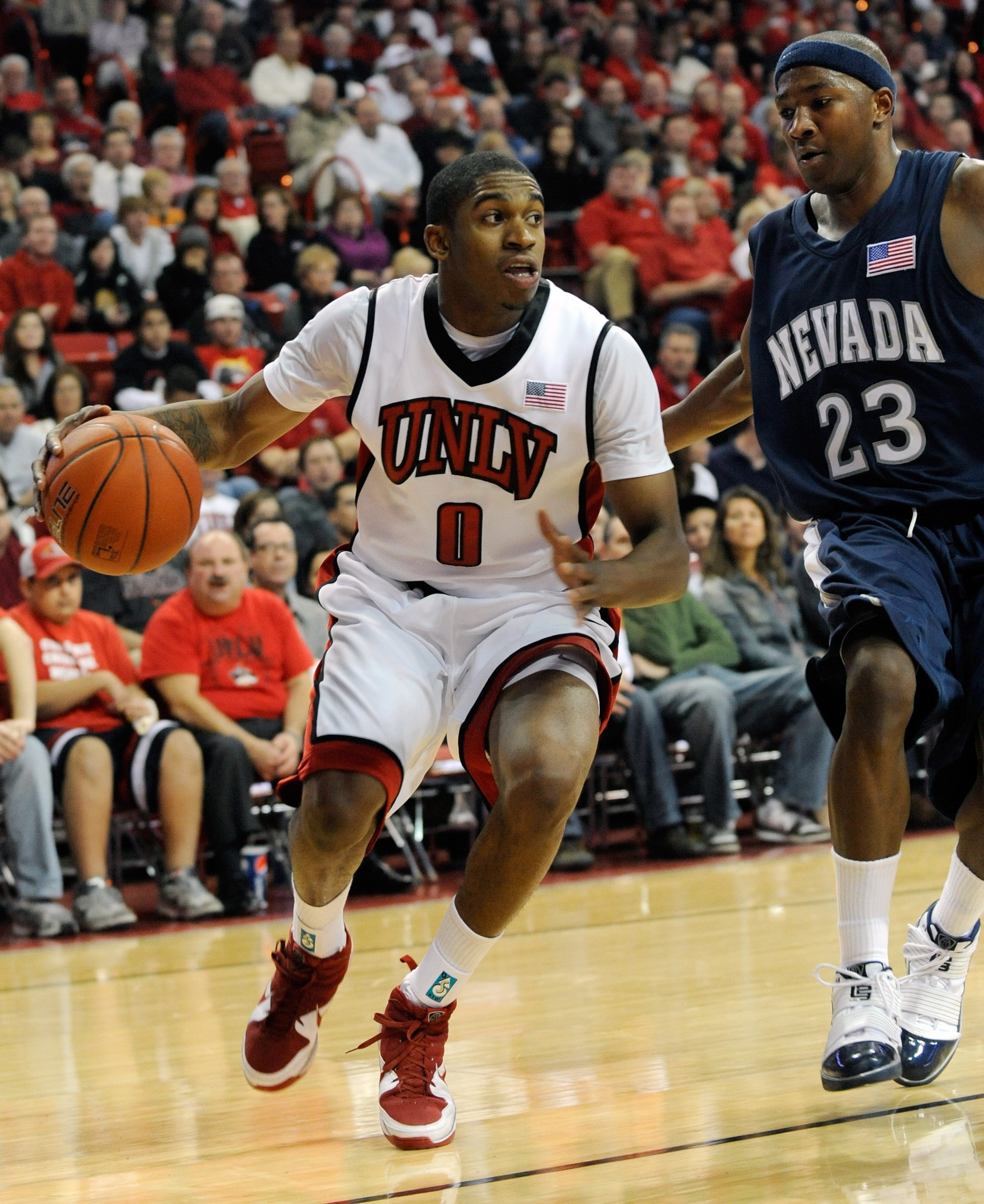 LAS VEGAS - NOVEMBER 18: Oscar Bellfield #0 of the UNLV Rebels drives around Armon Johnson #23 of the Nevada Wolf Pack during their game at the Thomas & Mack Center on November 18, 2009 in Las Vegas, Nevada. UNLV won 88-75. (Photo by Ethan Miller/Getty LAS VEGAS - NOVEMBER 18: Oscar Bellfield #0 of the UNLV Rebels drives around Armon Johnson #23 of the Nevada Wolf Pack during their game at the Thomas & Mack Center on November 18, 2009 in Las Vegas, Nevada. UNLV won 88-75. (Photo by Ethan Miller/Getty
