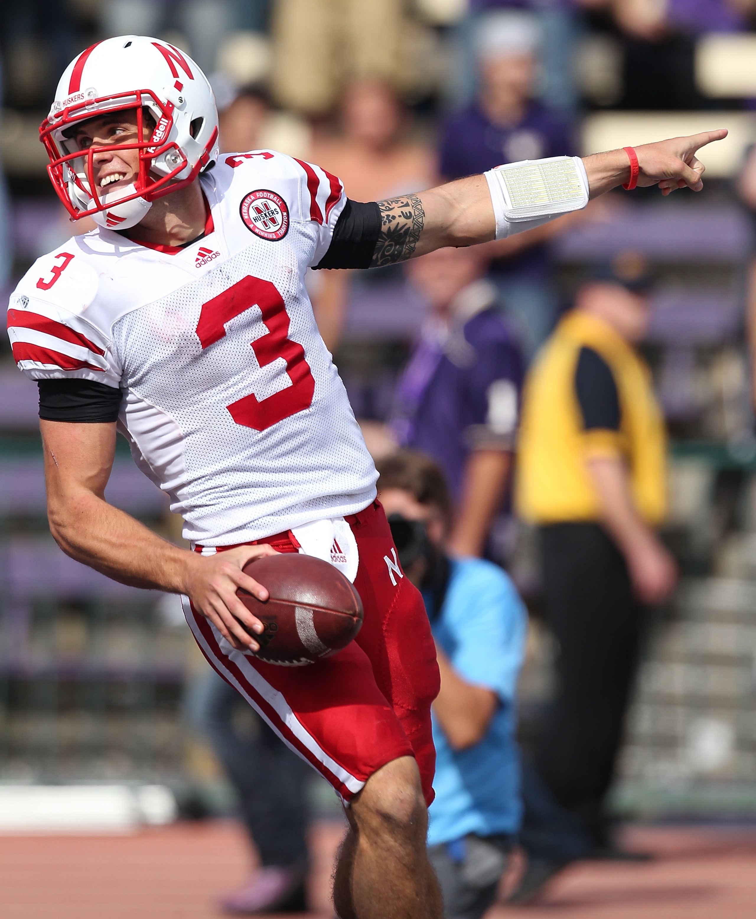 SEATTLE - SEPTEMBER 18:  Quarterback Taylor Martinez #3 of the Nebraska Cornhuskers celebrates after scoring on an 80 yard touchdown run in the third quarter against the Washington Huskies on September 18, 2010 at Husky Stadium in Seattle, Washington. The