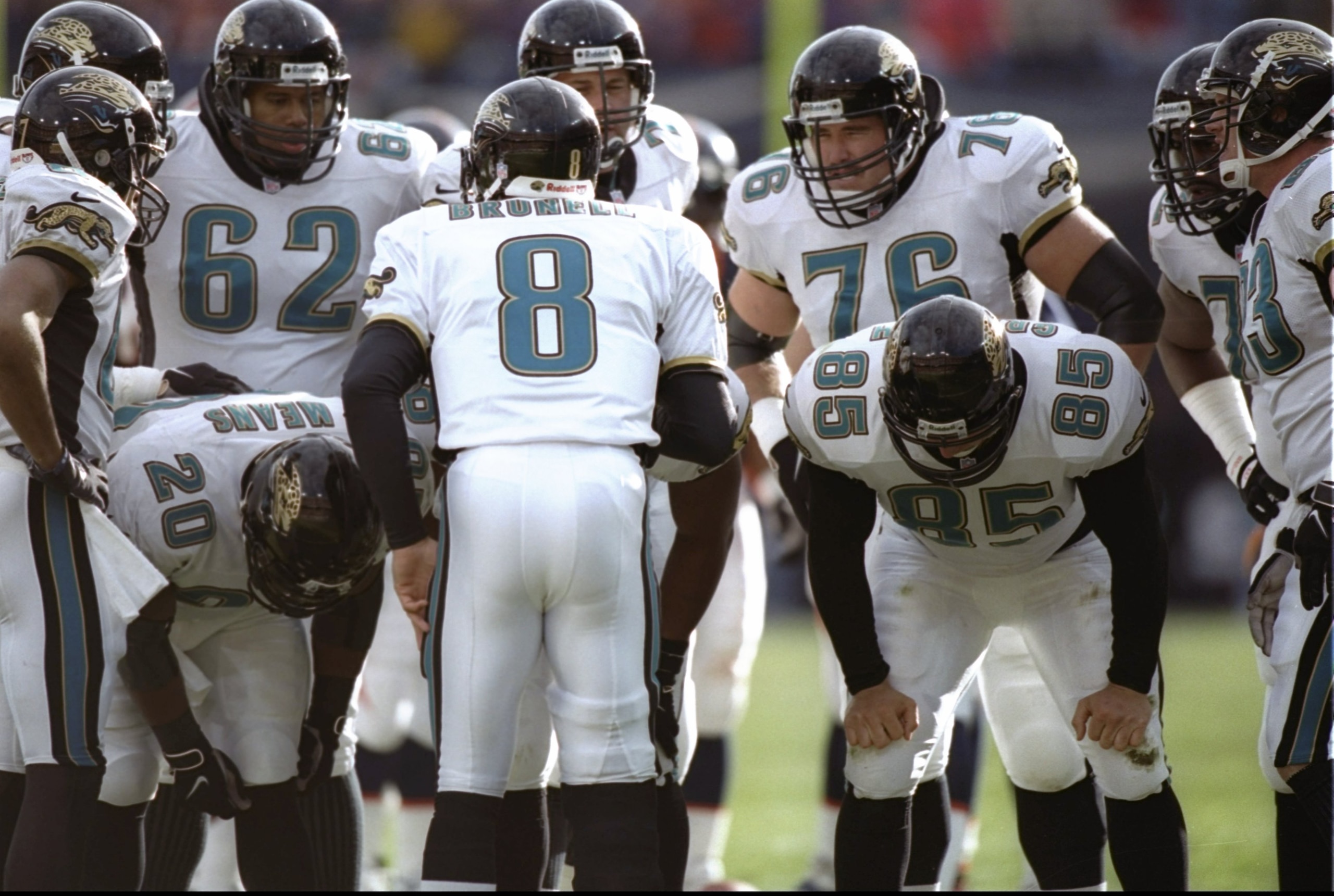 27 Dec 1997:  Quarterback Mark Brunell stands in the huddle with teammates, tight end Rich Griffith and running back Natrone Means of the Jacksonville Jaguars during a playoff game against the Denver Broncos at Mile High Stadium in Denver, Colorado.  The