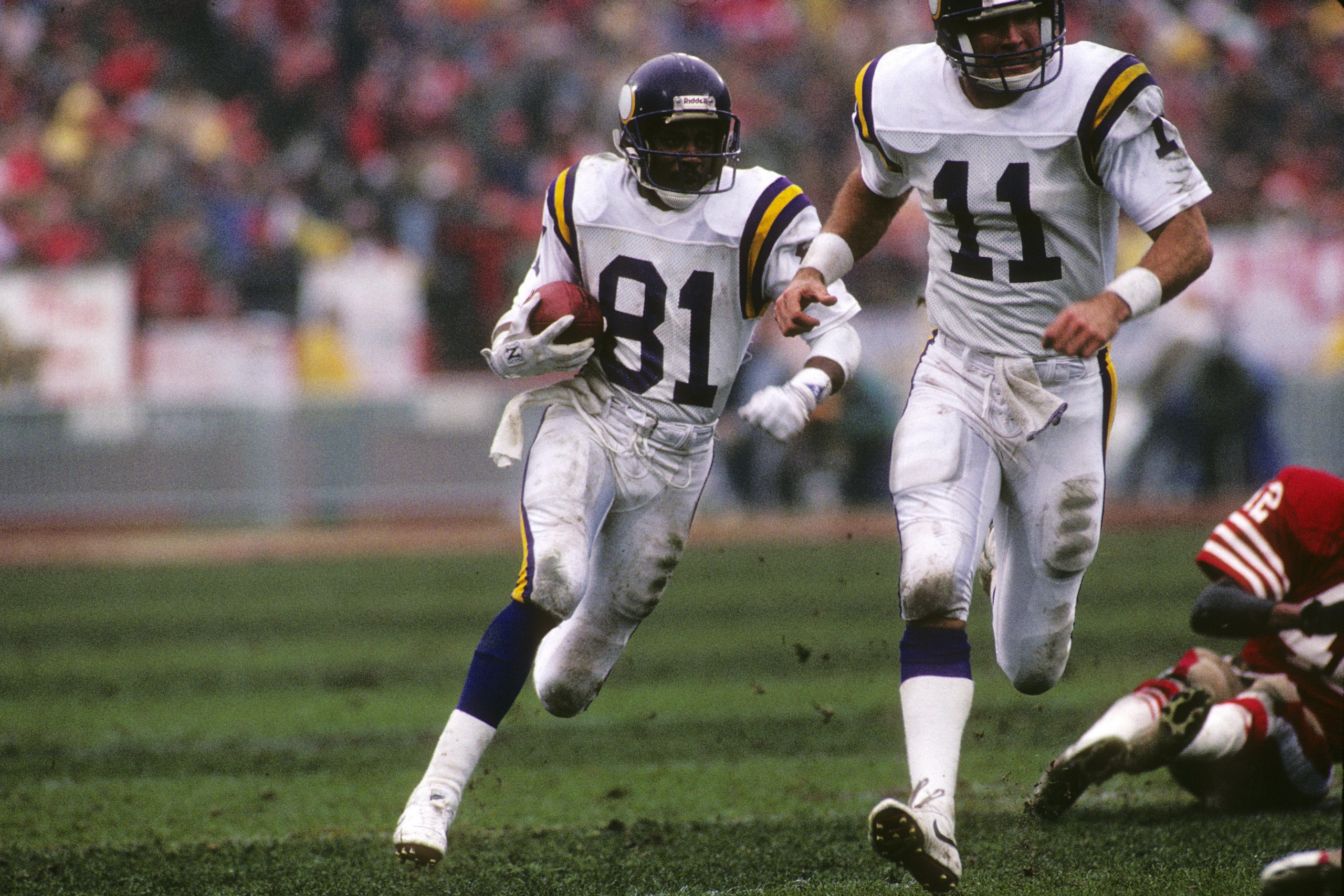 SAN FRANCISCO - JANUARY 9:  Wide receiver Anthony Carter #81 of the Minnesota Vikings follows teammate Wade Wilson #11 during the 1987 NFC Divisional Playoffs against the San Francisco 49ers at Candlestick Park on January 9, 1988 in San Francisco, Califor
