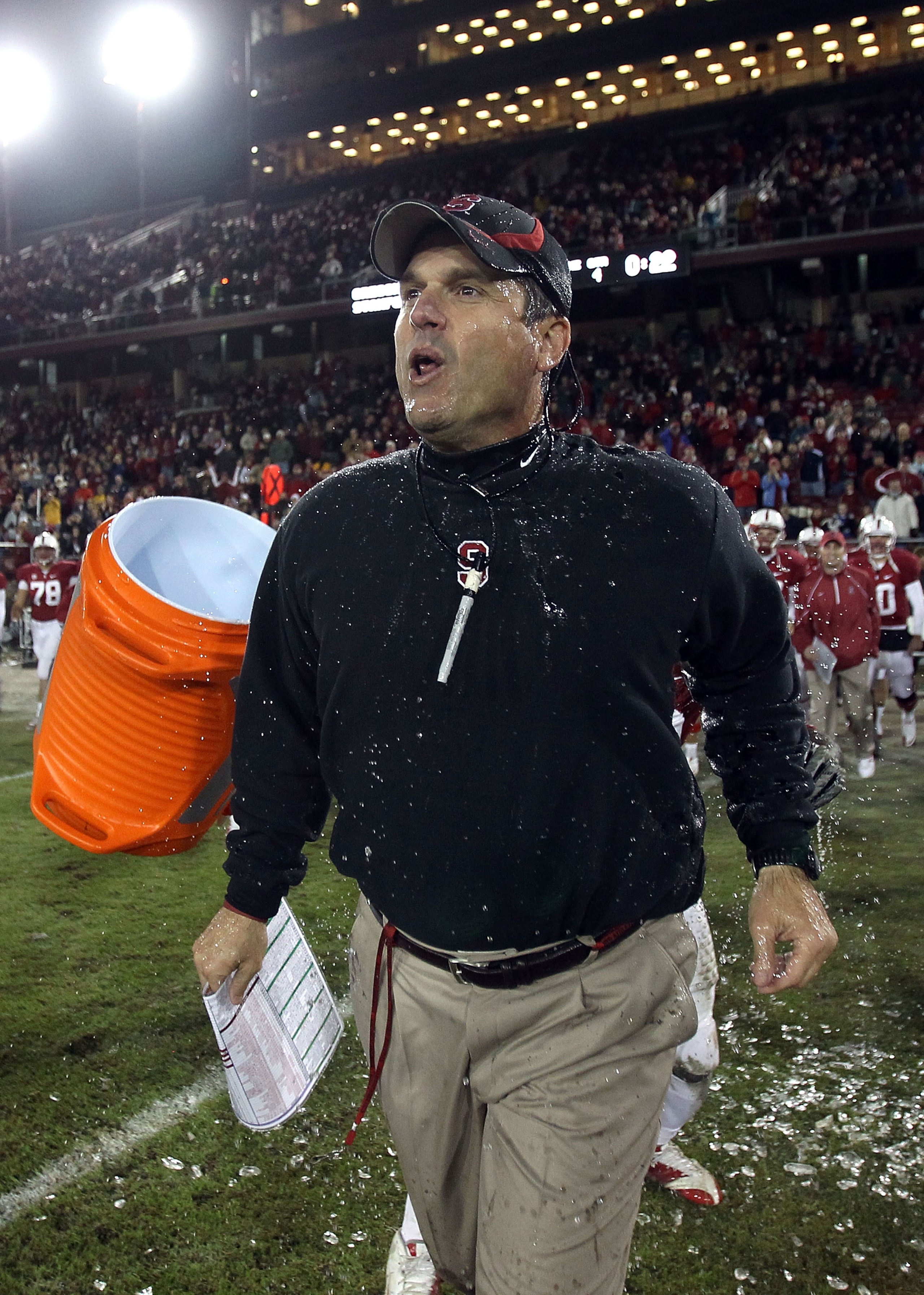 PALO ALTO, CA - NOVEMBER 27:  Head coach Jim Harbaugh of the Stanford Cardinal is covered with water from a Gatorade cooler by Andrew Luck #12 and Chike Amajoyi #43 after the Cardinal beat the Oregon State Beavers at Stanford Stadium on November 27, 2010