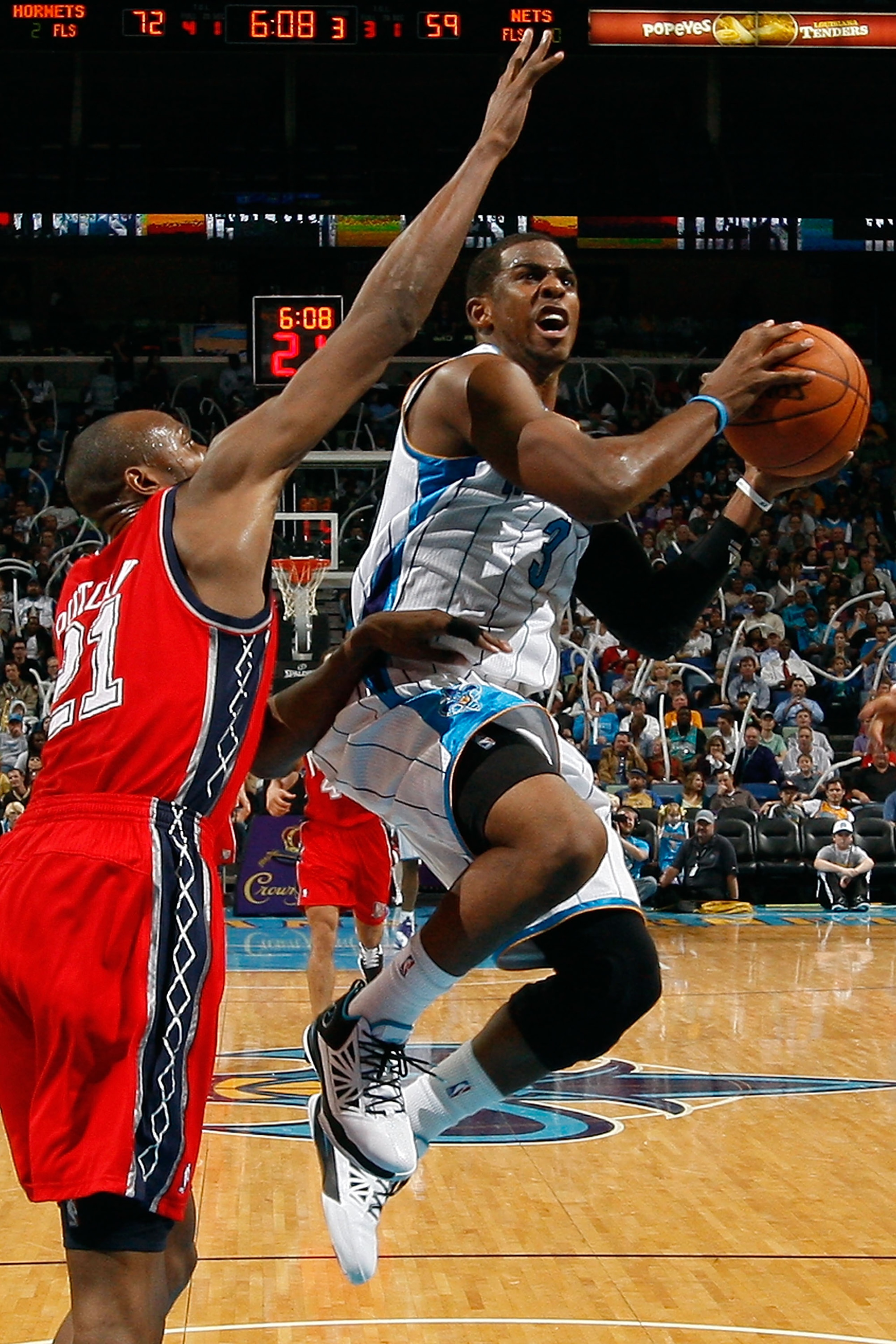 NEW ORLEANS, LA - DECEMBER 22: Chris Paul #3 of the New Orleans Hornets shoots the ball over Travis Outlaw #21 of the New Jersey Nets at the New Orleans Arena on December 22, 2010 in New Orleans, Louisiana. The Hornets defeated the Nets 105-91. NOTE NEW ORLEANS, LA - DECEMBER 22: Chris Paul #3 of the New Orleans Hornets shoots the ball over Travis Outlaw #21 of the New Jersey Nets at the New Orleans Arena on December 22, 2010 in New Orleans, Louisiana. The Hornets defeated the Nets 105-91. NOTE
