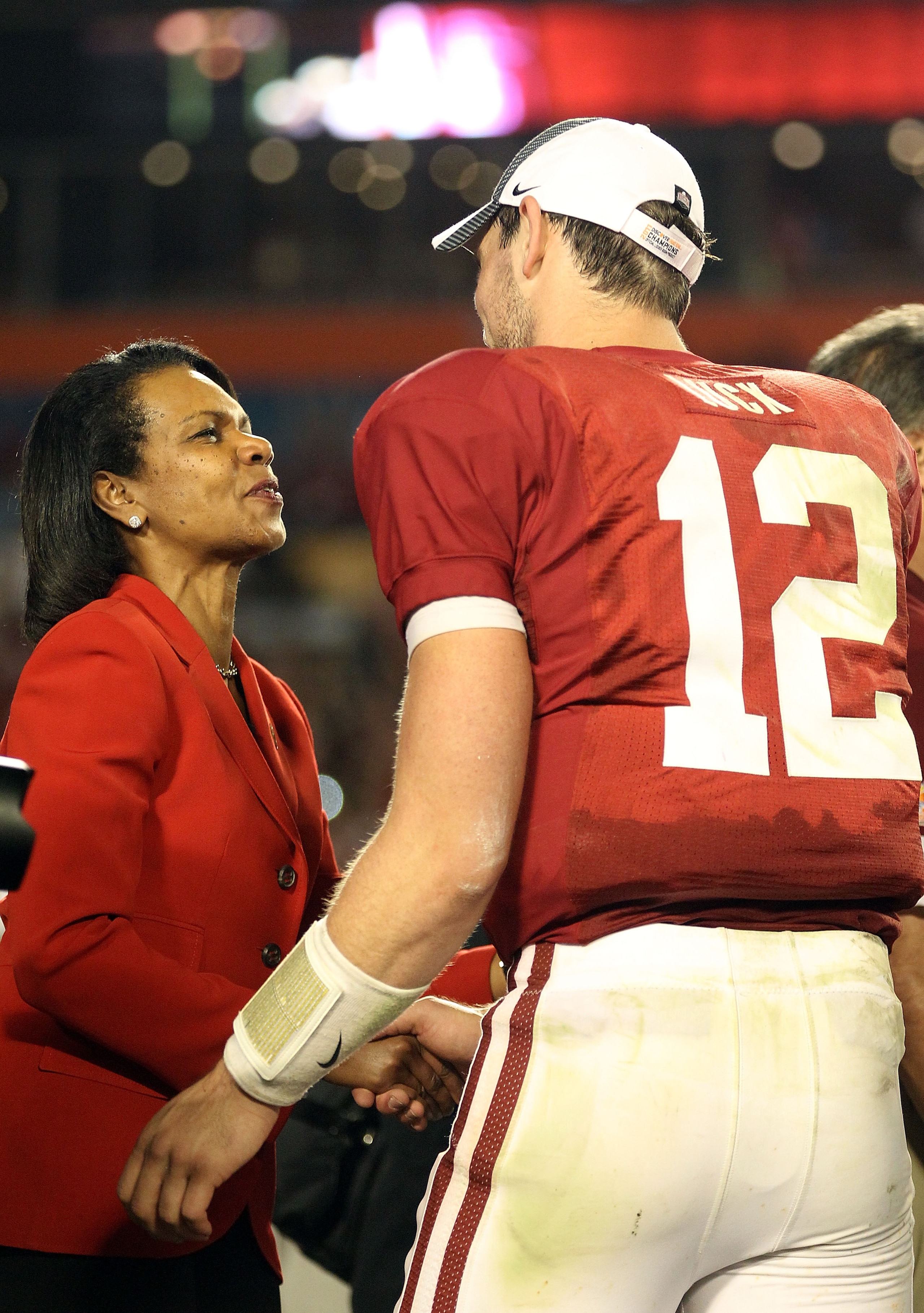 MIAMI, FL - JANUARY 03: Condoleezza Rice (L) congratulates Orange Bowl MVP Andrew Luck of the Stanford Cardinal after Stanford won 40-12 against the Virginia Tech Hokies during the 2011 Discover Orange Bowl at Sun Life Stadium on January 3, 2011 in Miami,