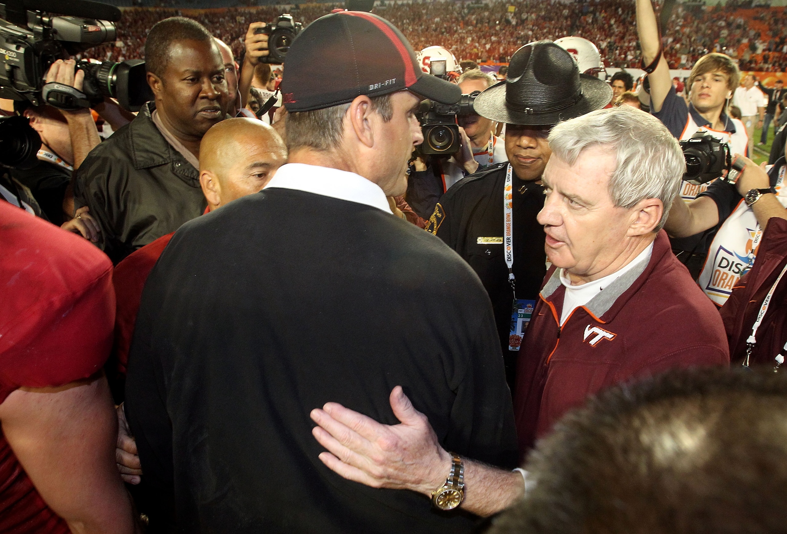 MIAMI, FL - JANUARY 03: Head coach Frank Beamer of the Virginia Tech Hokies congratulates head coach Jim Harbaugh (L) of the Stanford Cardinal after Stanford won 40-12 during the 2011 Discover Orange Bowl at Sun Life Stadium on January 3, 2011 in Miami, F