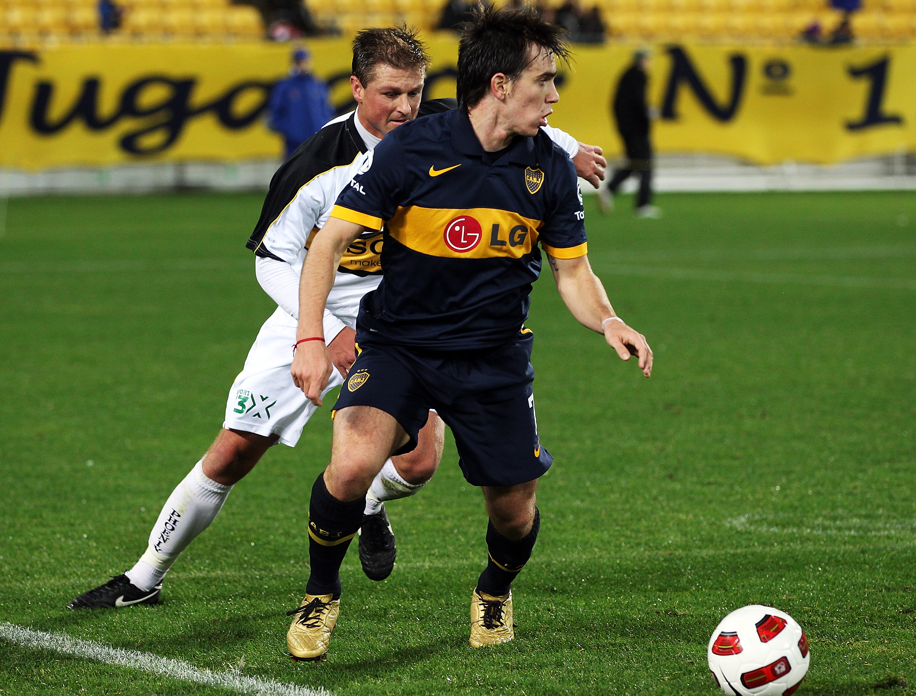WELLINGTON, NEW ZEALAND - JULY 23:  Pablo Mouche of the Boca Juniors gets past Ben Sigmund of the Phoenix during the pre-season friendly match between Wellington Phoenix and Boca Juniors at Westpac Stadium on July 23, 2010 in Wellington, New Zealand.  (Ph