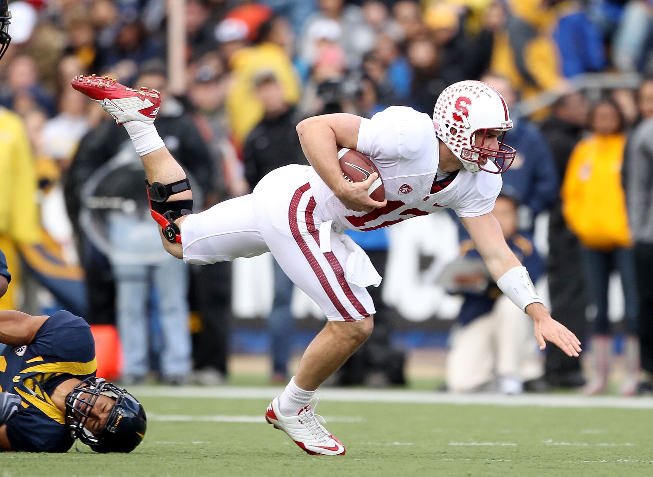 BERKELEY, CA - NOVEMBER 20:  Andrew Luck #12 of the Stanford Cardinal jumps over Sean Cattouse #11  the California Golden Bears at California Memorial Stadium on November 20, 2010 in Berkeley, California.  (Photo by Ezra Shaw/Getty Images)
