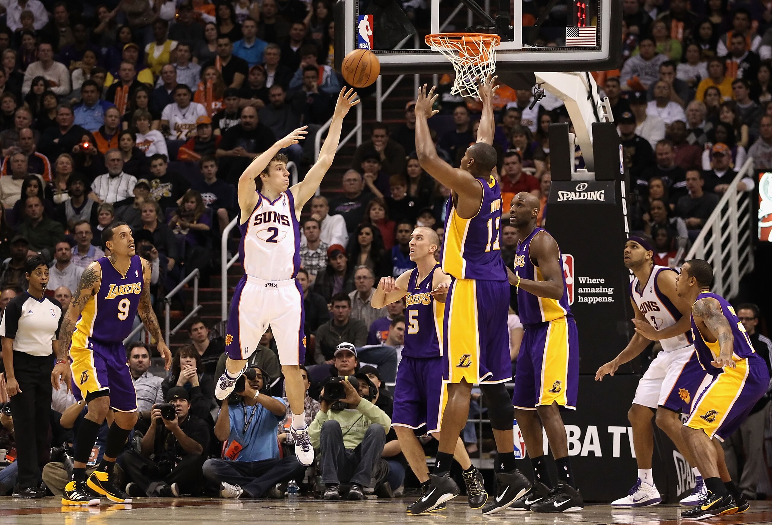 PHOENIX - JANUARY 05:  Goran Dragic #2 of the Phoenix Suns passes the ball over Andrew Bynum #17 of the Los Angeles Lakers during the NBA game at US Airways Center on December 23, 2011 in Phoenix, Arizona. The Lakers defeated the Suns 99-95. NOTE TO USER: