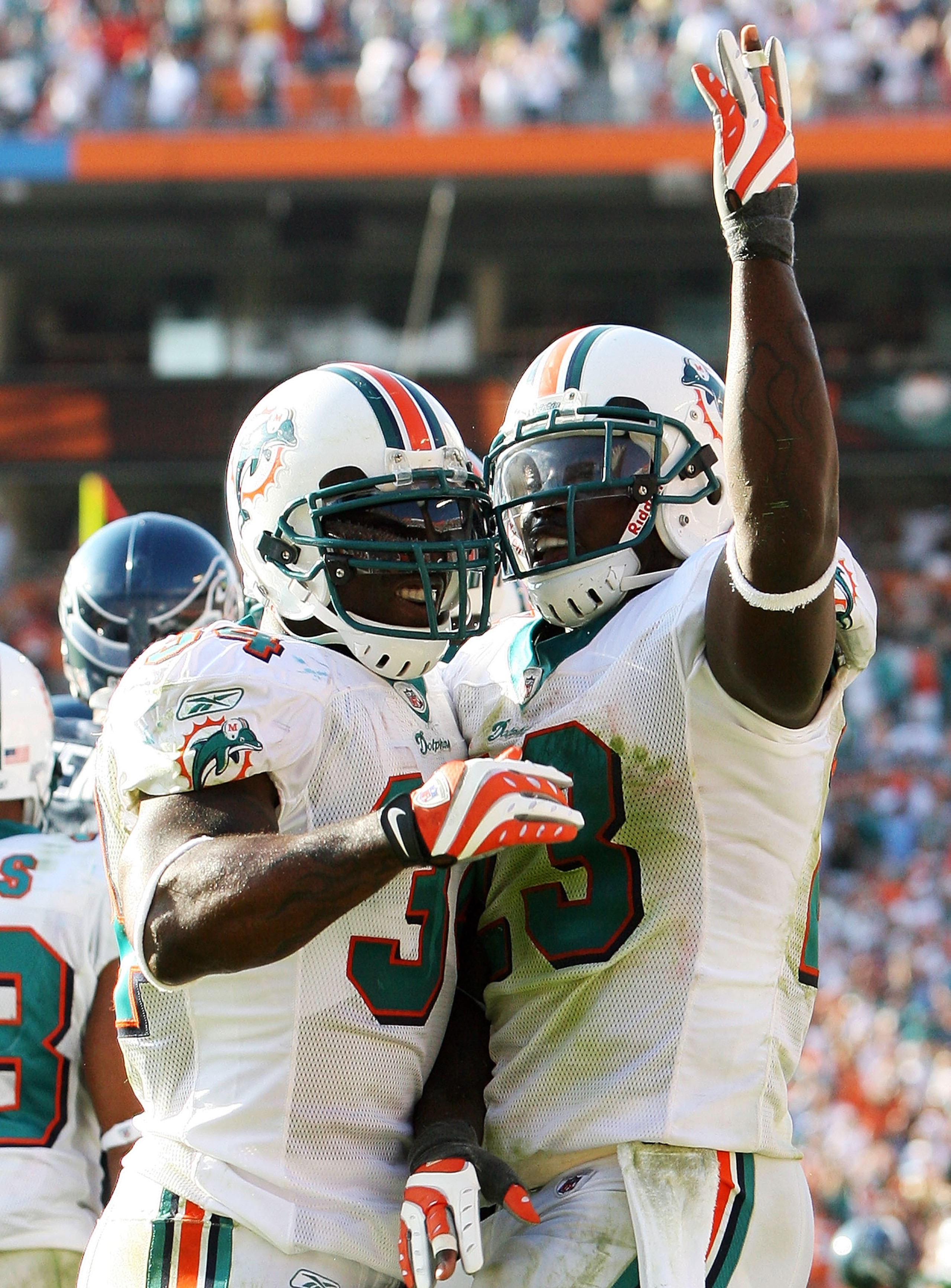 MIAMI - NOVEMBER 09: Running back Ronnie Brown #23 and Ricky Williams #34 of the Miami Dolphins celebrate after Brown's touchdown run in the fourth quarter against the Seattle Seahawks at Dolphin Stadium on November 9, 2008 in Miami, Florida. The Dolphin MIAMI - NOVEMBER 09: Running back Ronnie Brown #23 and Ricky Williams #34 of the Miami Dolphins celebrate after Brown's touchdown run in the fourth quarter against the Seattle Seahawks at Dolphin Stadium on November 9, 2008 in Miami, Florida. The Dolphin