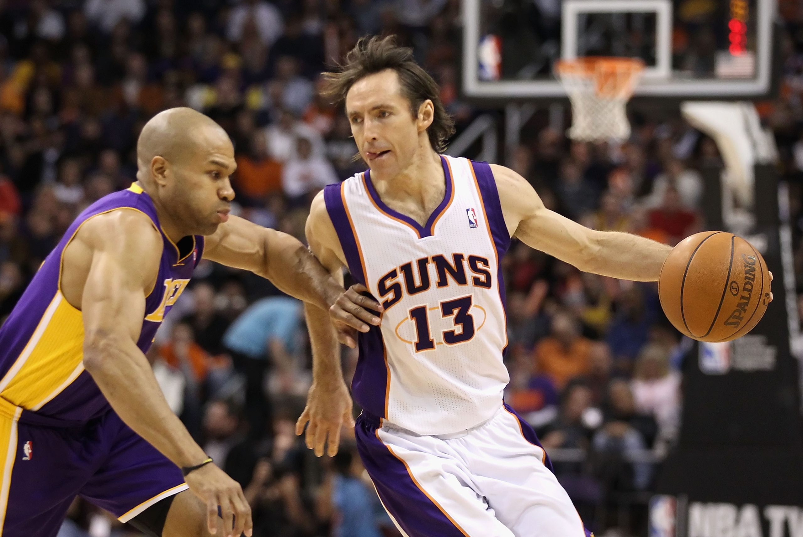 PHOENIX - JANUARY 05:  Steve Nash #13 of the Phoenix Suns handles the ball under pressure from Derek Fisher #2 of the Los Angeles Lakers during the NBA game at US Airways Center on December 23, 2011 in Phoenix, Arizona. NOTE TO USER: User expressly acknow