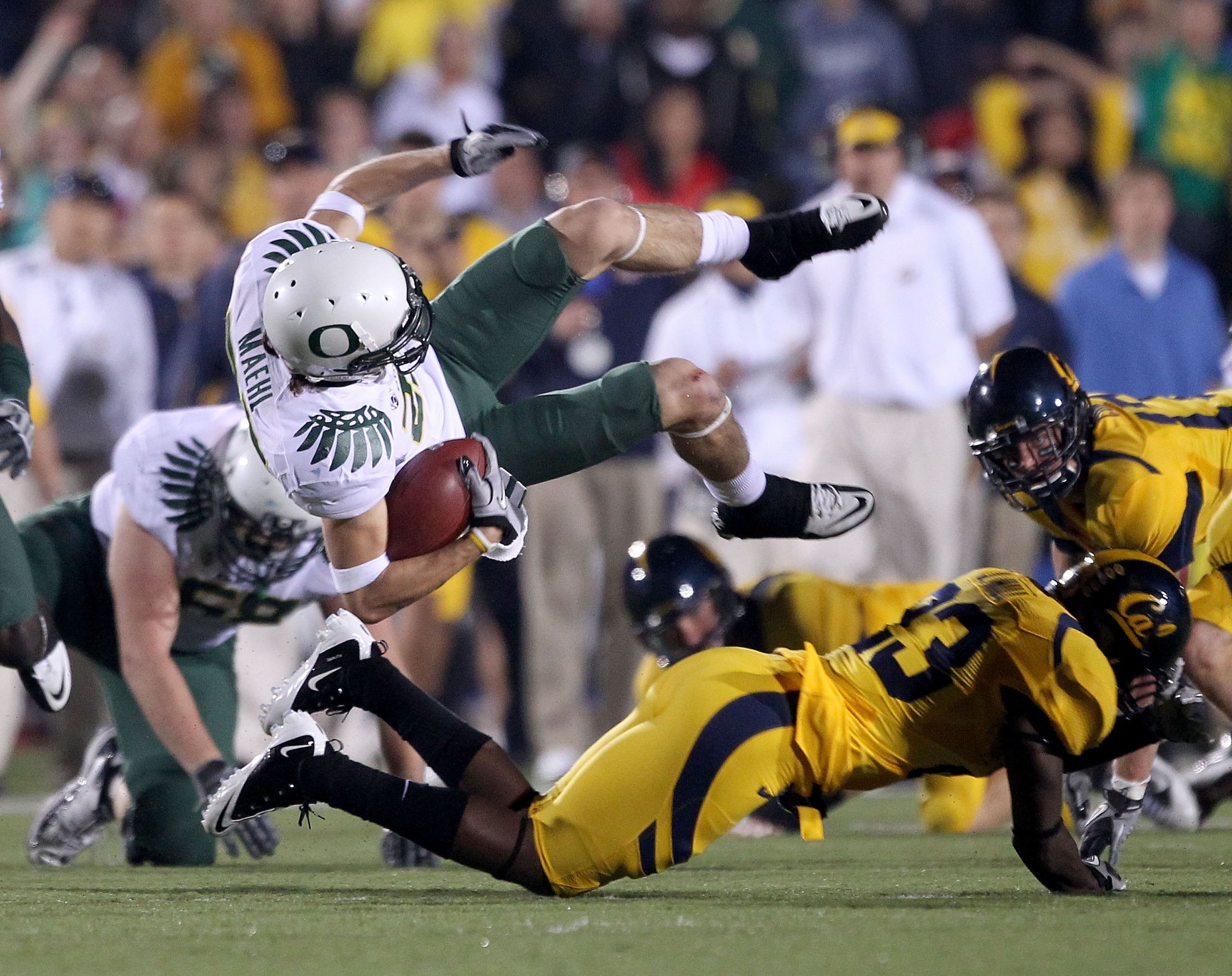 BERKELEY, CA - NOVEMBER 13:  Jeff Maehl #23 of the Oregon Ducks flies through the air after being hit by Josh Hill #23 of the California Golden Bears  at California Memorial Stadium on November 13, 2010 in Berkeley, California.  (Photo by Ezra Shaw/Getty