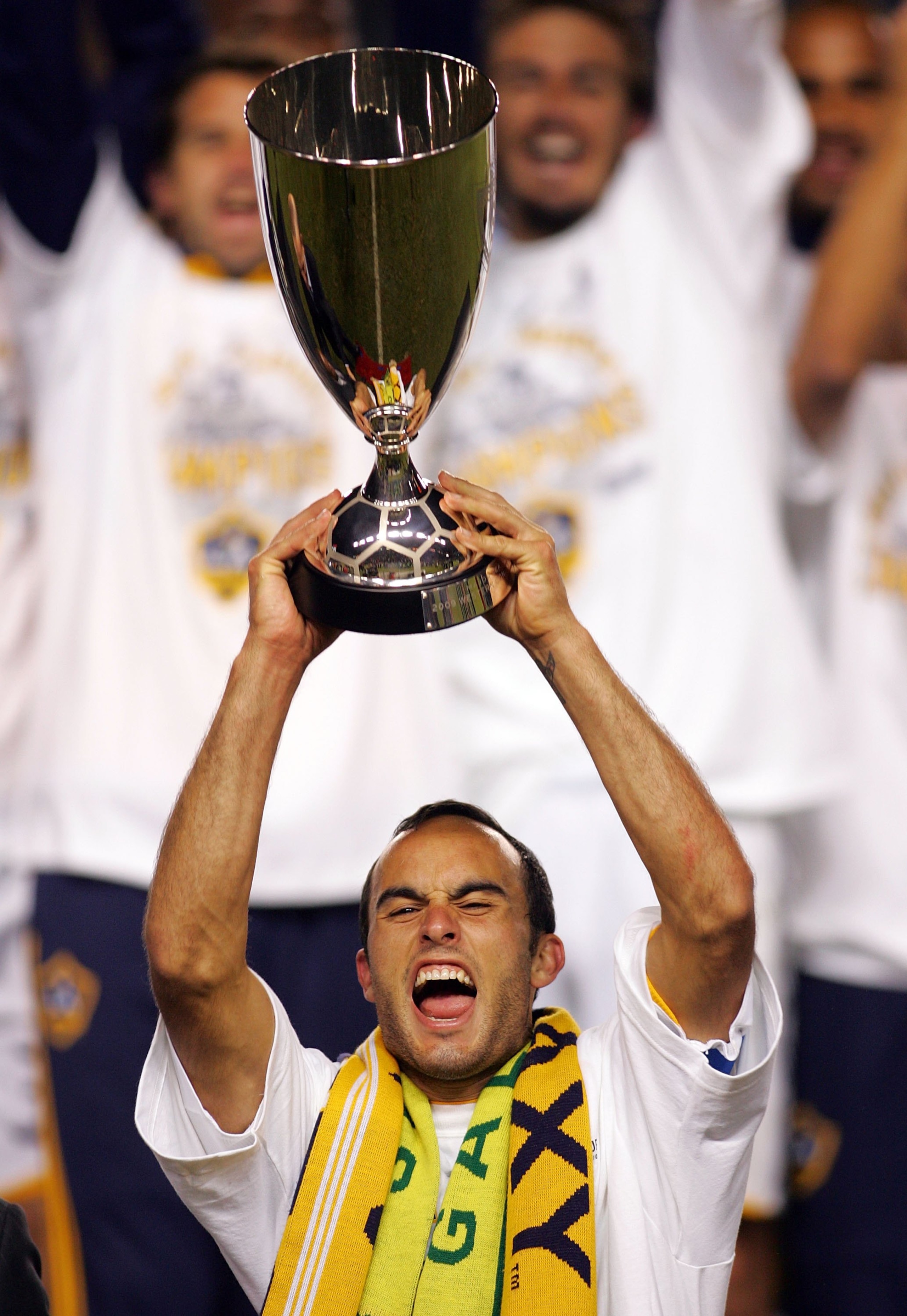 CARSON, CA - NOVEMBER 13:  Captain Landon Donovan #10 of the Los Angeles Galaxy hoists the MLS Western Conference Trophy in front of his teammates after the Galaxy won their MLS Western Conference Championship match against the Houston Dynamo 2-0 at The H