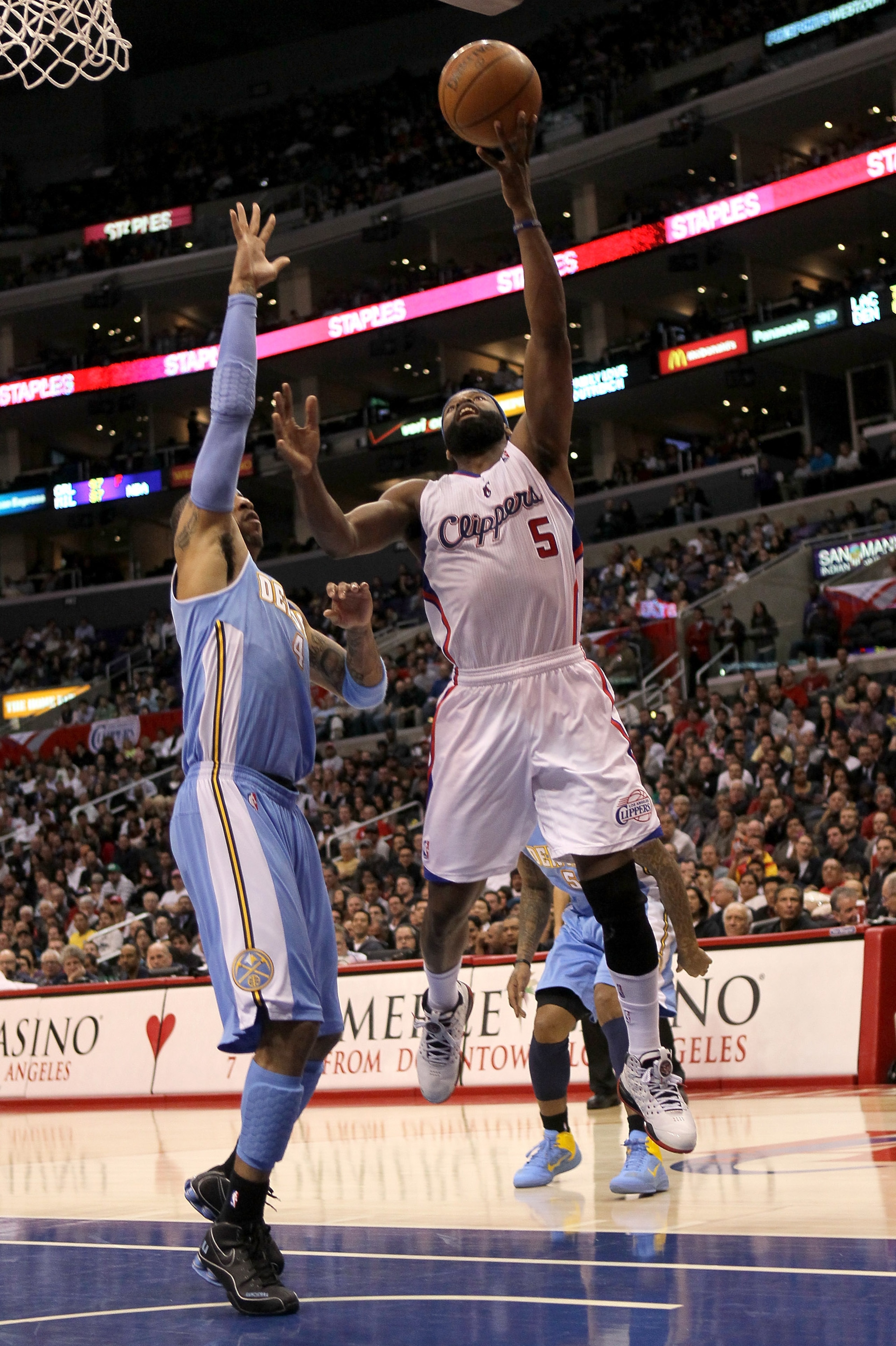 LOS ANGELES, CA - JANUARY 05:  Baron Davis #5 of the Los Angeles Clippers goes up for a shot over Kenyon Martin #5 of the Denver Nuggets at Staples Center on January 5, 2011  in Los Angeles, California. The Clippers won 106-93.  NOTE TO USER: User express