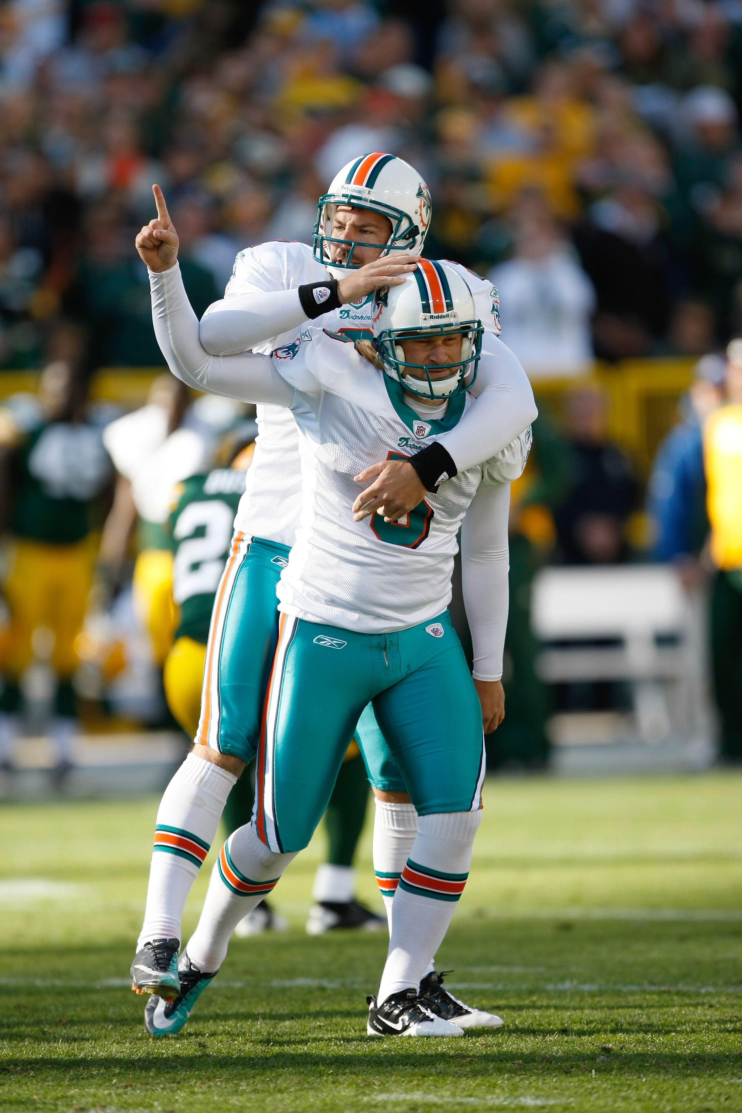 GREEN BAY, WI - OCTOBER 17: Dan Carpenter #5 and Brandon Fields #2 of the Miami Dolphins celebrate the winning field goal in overtime against the Green Bay Packers at Lambeau Field on October 17, 2010 in Green Bay, Wisconsin. The Dolphins defeated the Pac GREEN BAY, WI - OCTOBER 17: Dan Carpenter #5 and Brandon Fields #2 of the Miami Dolphins celebrate the winning field goal in overtime against the Green Bay Packers at Lambeau Field on October 17, 2010 in Green Bay, Wisconsin. The Dolphins defeated the Pac