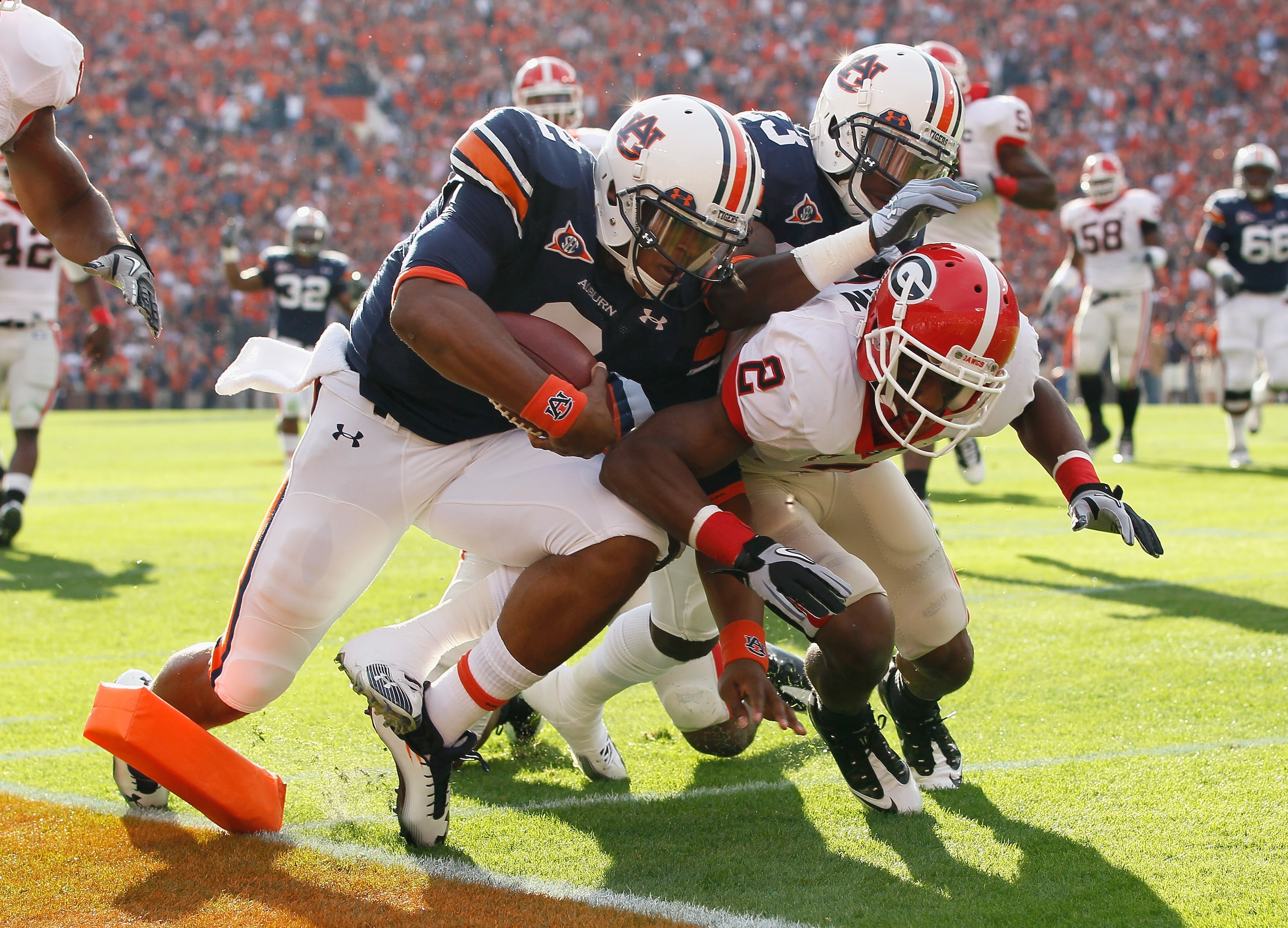AUBURN, AL - NOVEMBER 13:  Quarterback Cameron Newton #2 of the Auburn Tigers stays in bounds as he scores a touchdown against Brandon Boykin #2 of the Georgia Bulldogs at Jordan-Hare Stadium on November 13, 2010 in Auburn, Alabama.  (Photo by Kevin C. Co