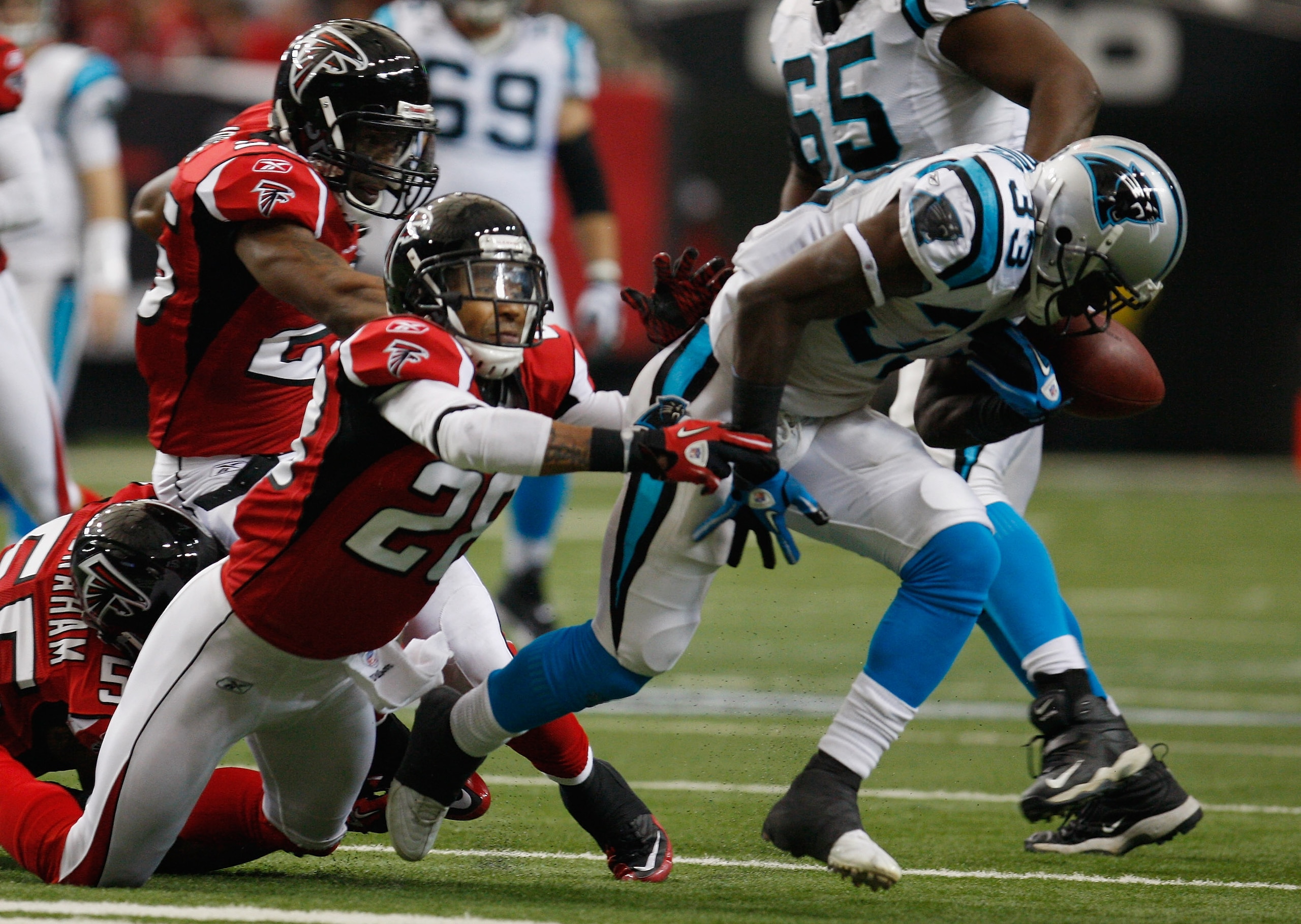 ATLANTA, GA - JANUARY 02: Mike Goodson#33 of the Carolina Panthers loses a fumble in the second quarter after being hit by Thomas DeCoud #28 of the Atlanta Falcons at the Georgia Dome on January 2, 2011 in Atlanta, Georgia. (Photo by Scott Halleran/Gett ATLANTA, GA - JANUARY 02: Mike Goodson#33 of the Carolina Panthers loses a fumble in the second quarter after being hit by Thomas DeCoud #28 of the Atlanta Falcons at the Georgia Dome on January 2, 2011 in Atlanta, Georgia. (Photo by Scott Halleran/Gett