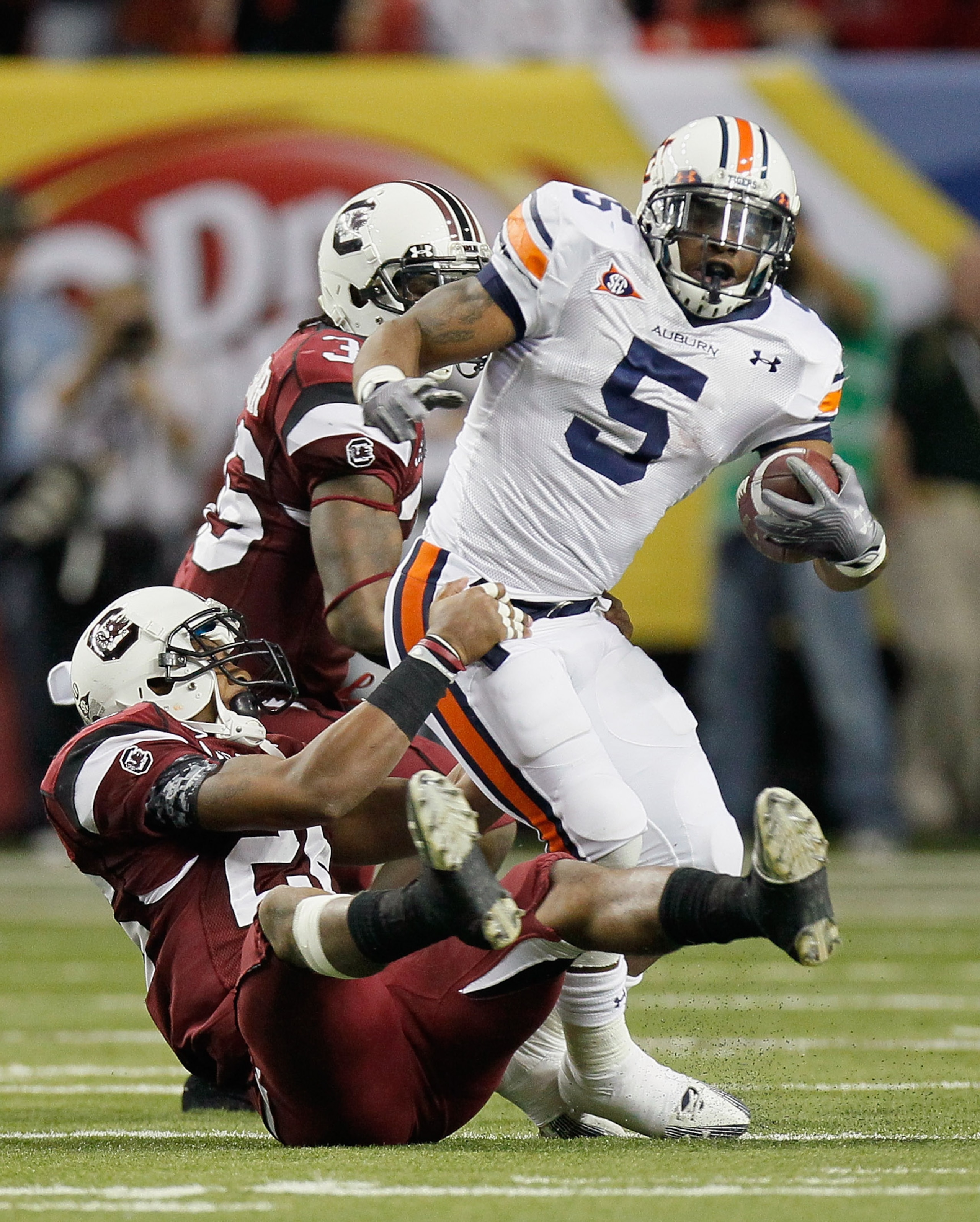 ATLANTA, GA - DECEMBER 04:  Michael Dyer #5 of the Auburn Tigers rushes is tackled by Antonio Allen #26 of the South Carolina Gamecocks during the 2010 SEC Championship at Georgia Dome on December 4, 2010 in Atlanta, Georgia.  (Photo by Kevin C. Cox/Getty