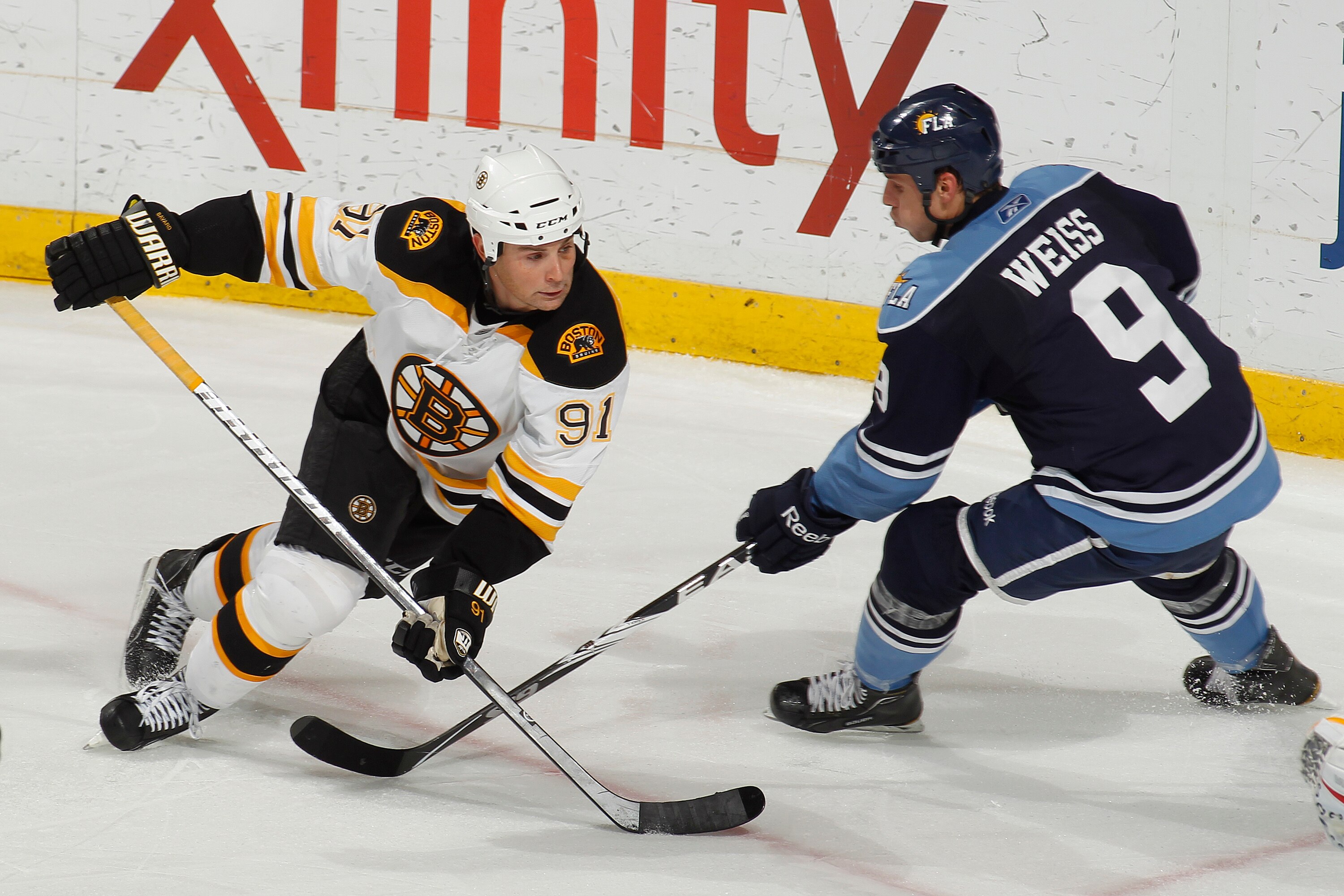 SUNRISE, FL - DECEMBER 27: Stephen Weiss #9 of the Florida Panthers and Marc Savard #91 of the Boston Bruins skate for control of the puck on December 27, 2010 at the BankAtlantic Center in Sunrise, Florida. The Bruins defeated the Panthers 3-2 in a shoot