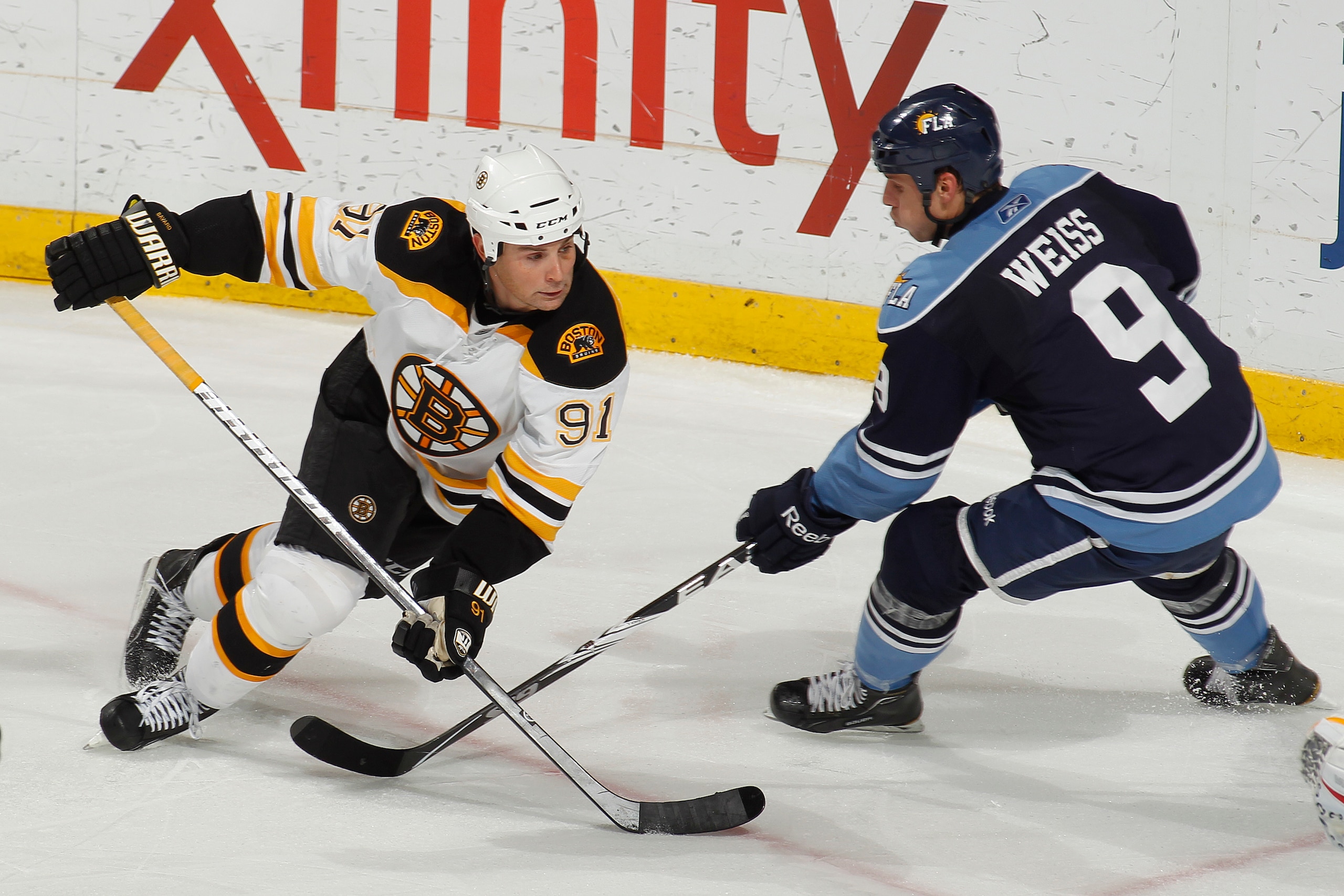SUNRISE, FL - DECEMBER 27: Stephen Weiss #9 of the Florida Panthers and Marc Savard #91 of the Boston Bruins skate for control of the puck on December 27, 2010 at the BankAtlantic Center in Sunrise, Florida. The Bruins defeated the Panthers 3-2 in a shoot
