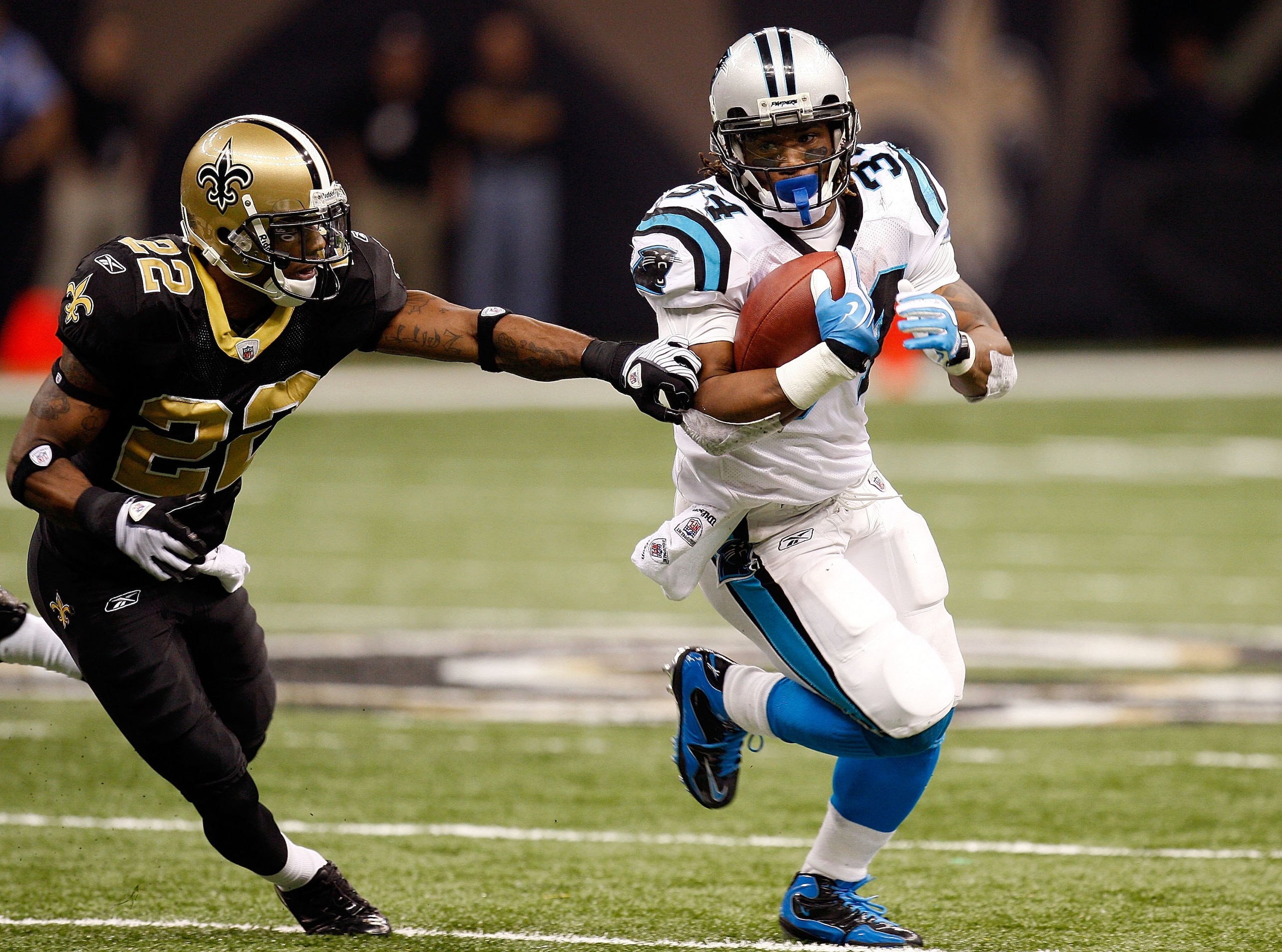 NEW ORLEANS - NOVEMBER 08: Running back DeAngelo Williams #34 of the Carolina Panthers runs the ball against Tracy Porter #22 of the New Orleans Saints at Louisiana Superdome on November 8, 2009 in New Orleans, Louisiana. (Photo by Ronald Martinez/Gett NEW ORLEANS - NOVEMBER 08: Running back DeAngelo Williams #34 of the Carolina Panthers runs the ball against Tracy Porter #22 of the New Orleans Saints at Louisiana Superdome on November 8, 2009 in New Orleans, Louisiana. (Photo by Ronald Martinez/Gett