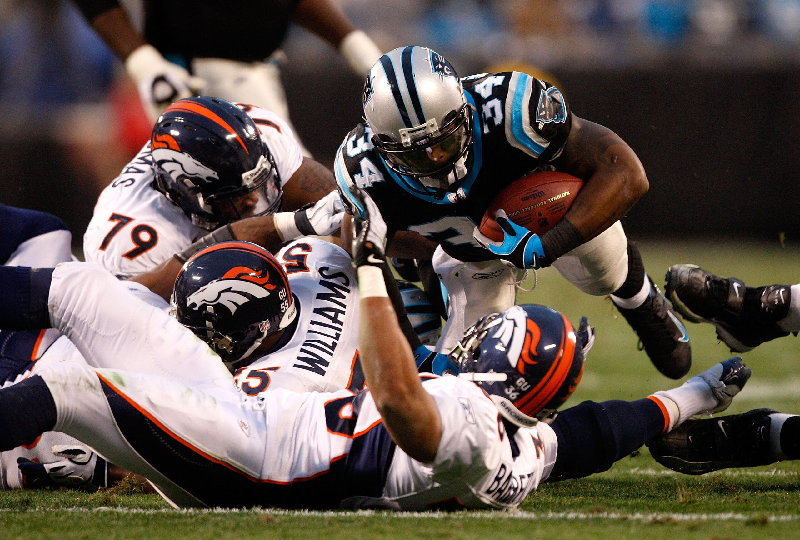 CHARLOTTE, NC - DECEMBER 14: The defense of the Denver Broncos tries to stop DeAngelo Williams #34 of the Carolina Panthers during their game at Bank of America Stadium on December 14, 2008 in Charlotte, North Carolina (Photo by Streeter Lecka/Getty Ima CHARLOTTE, NC - DECEMBER 14: The defense of the Denver Broncos tries to stop DeAngelo Williams #34 of the Carolina Panthers during their game at Bank of America Stadium on December 14, 2008 in Charlotte, North Carolina (Photo by Streeter Lecka/Getty Ima
