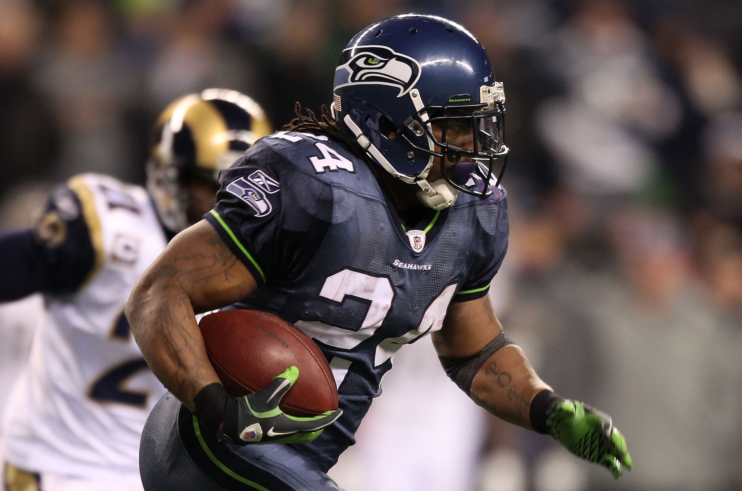 SEATTLE, WA - JANUARY 02: Running back Marshawn Lynch #24 of the Seattle Seahawks rushes with the ball against the St. Louis Rams during their game at Qwest Field on January 2, 2011 in Seattle, Washington. (Photo by Otto Greule Jr/Getty Images) SEATTLE, WA - JANUARY 02: Running back Marshawn Lynch #24 of the Seattle Seahawks rushes with the ball against the St. Louis Rams during their game at Qwest Field on January 2, 2011 in Seattle, Washington. (Photo by Otto Greule Jr/Getty Images)