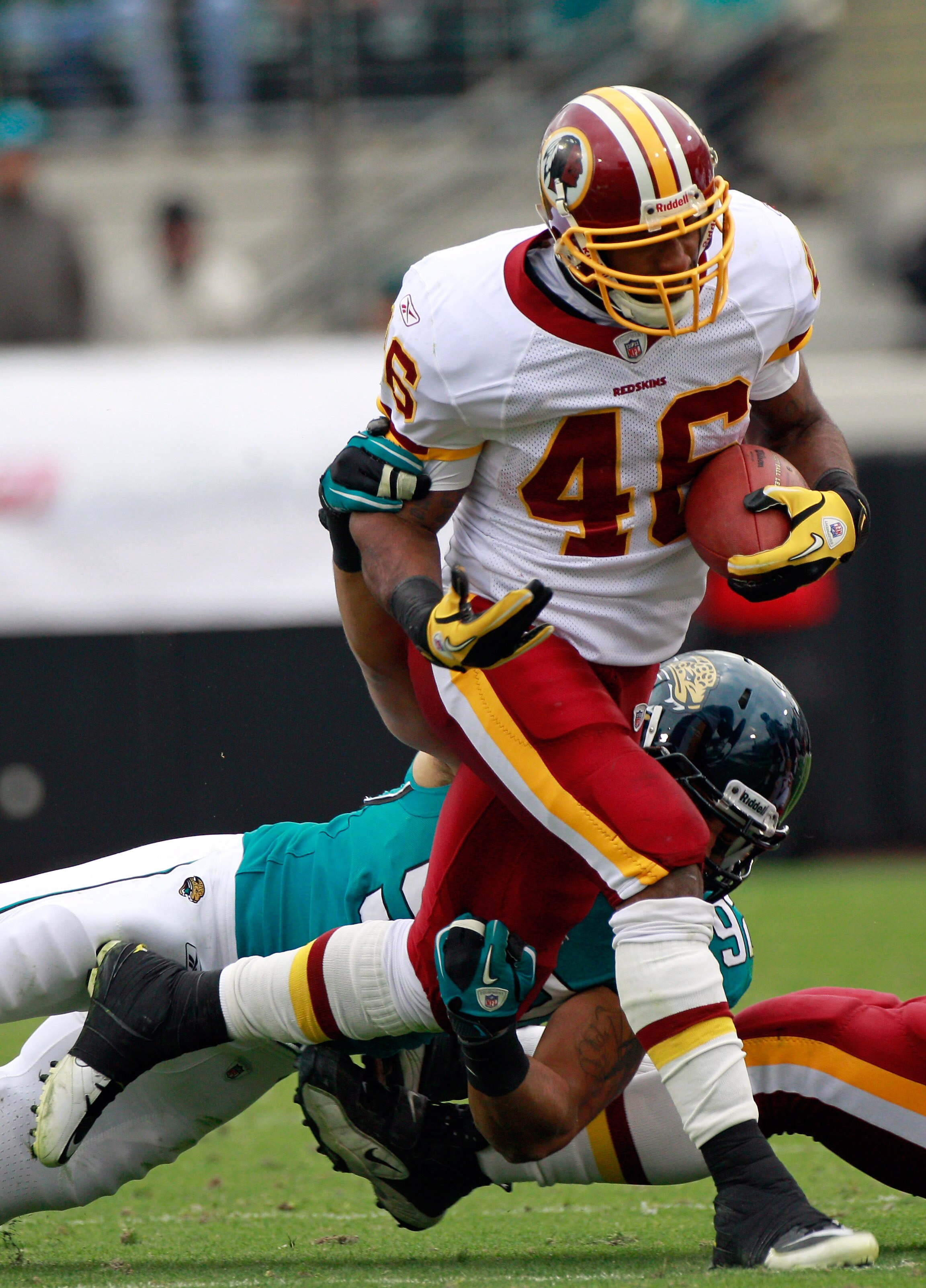 JACKSONVILLE, FL - DECEMBER 26: Austen Lane #92 of the Jacksonville Jaguars attempts to tackle Ryan Torain #46 of the Washington Redskins during the game at EverBank Field on December 26, 2010 in Jacksonville, Florida.  (Photo by Sam Greenwood/Getty Image