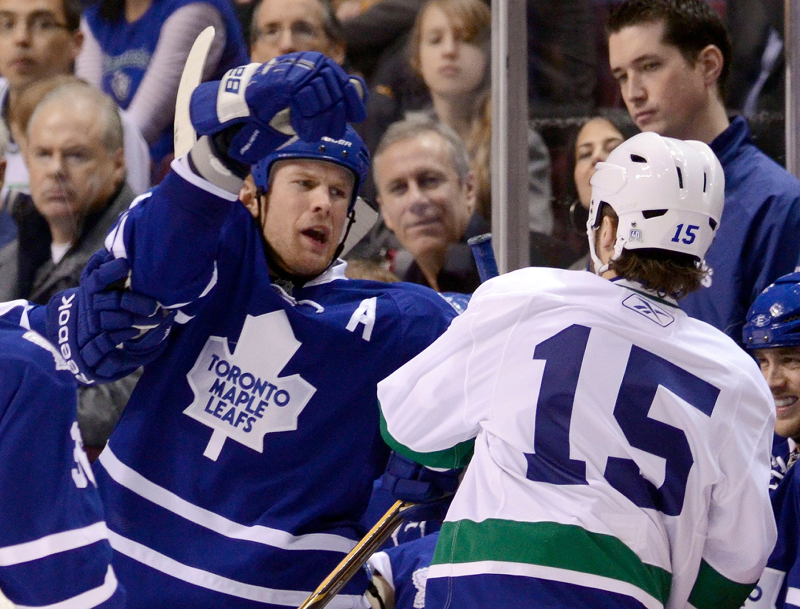 VANCOUVER, CANADA - DECEMBER 18: Tanner Glass #15 of the Vancouver Canucks and Mike Komisarek #8 of the Toronto Maple Leafs exchange words after the whistle during the second period in NHL action on December 18, 2010 at Rogers Arena in Vancouver, BC, Cana