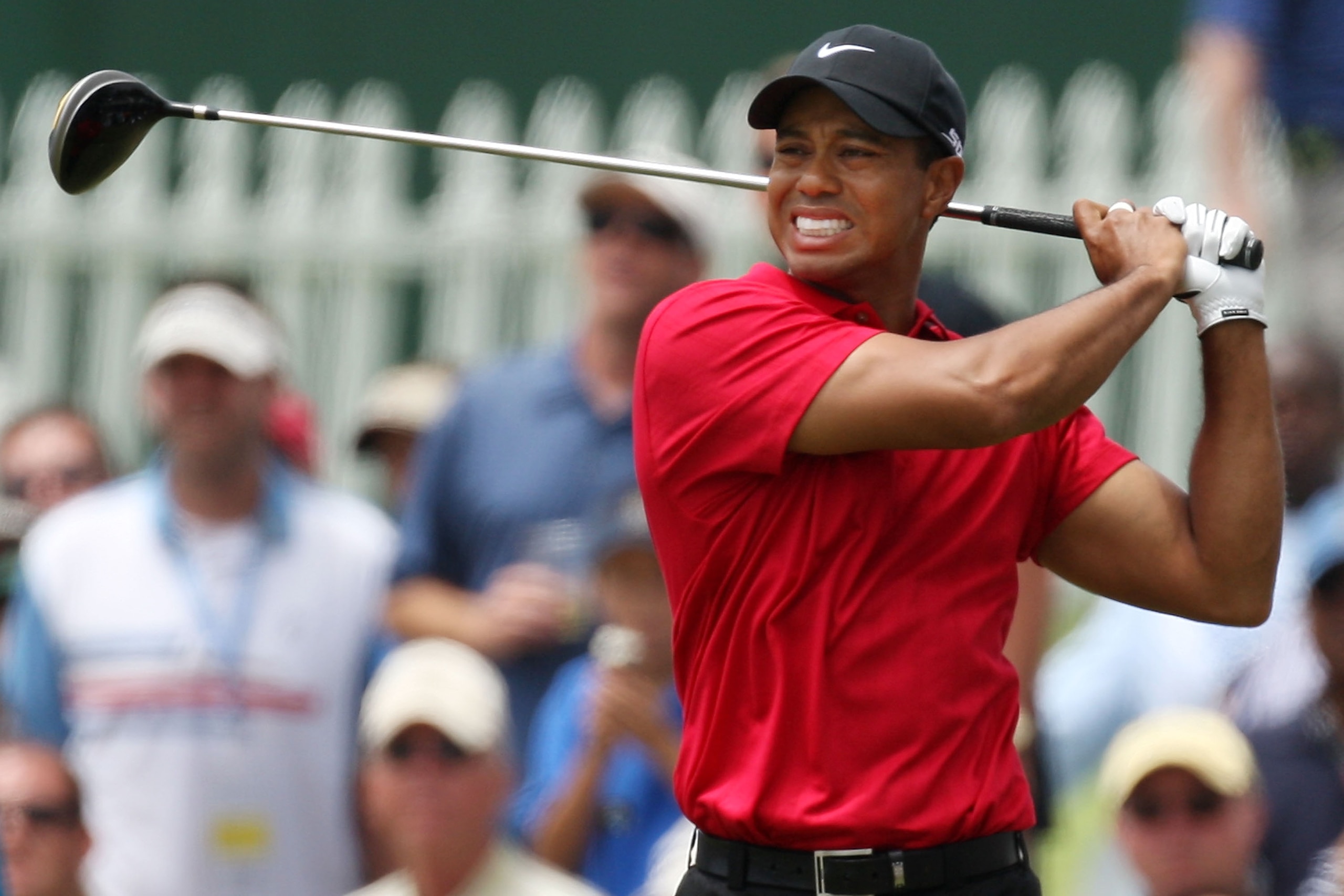 SAN DIEGO - JUNE 15:  Tiger Woods winces due to the pain from his knee injury after his tee shot during the final round of the 108th U.S. Open at the Torrey Pines Golf Course (South Course) on June 15, 2008 in San Diego, California.  (Photo by Ross Kinnai