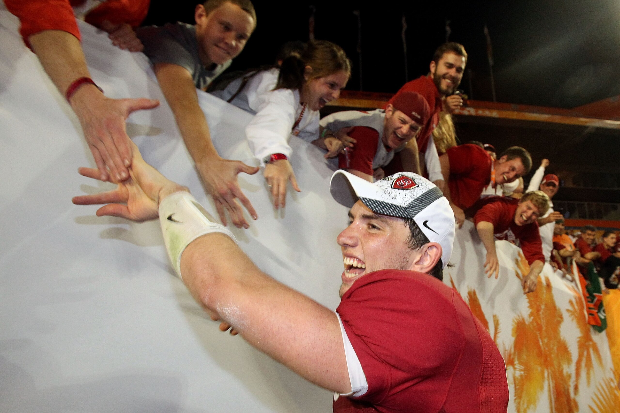 MIAMI, FL - JANUARY 03: Orange Bowl MVP Andrew Luck of the Stanford Cardinal celebrates with fans after Stanford won 40-14 against the Virginia Tech Hokies during the 2011 Discover Orange Bowl at Sun Life Stadium on January 3, 2011 in Miami, Florida. (P MIAMI, FL - JANUARY 03: Orange Bowl MVP Andrew Luck of the Stanford Cardinal celebrates with fans after Stanford won 40-14 against the Virginia Tech Hokies during the 2011 Discover Orange Bowl at Sun Life Stadium on January 3, 2011 in Miami, Florida. (P