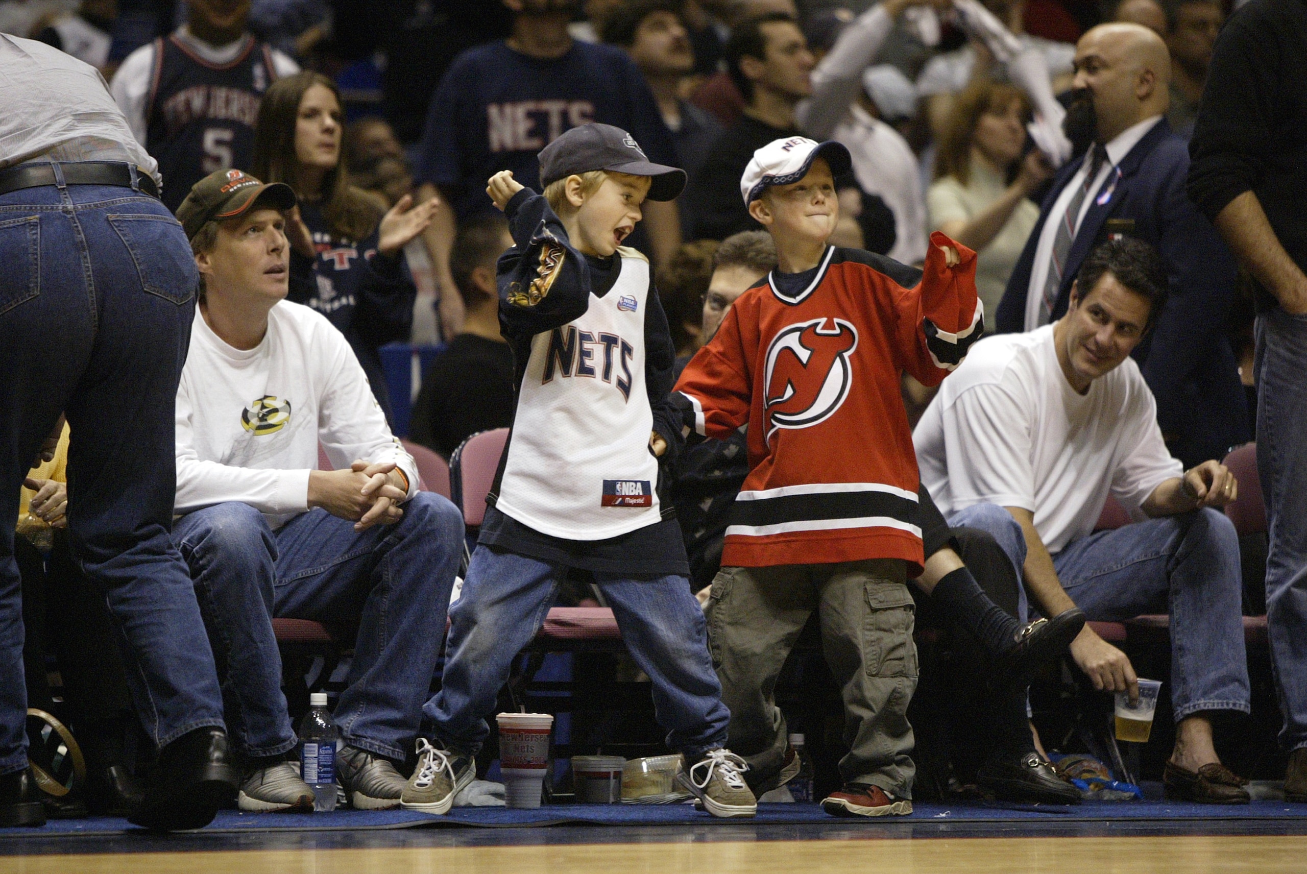 EAST RUTHERFORD, NJ - MAY 24:  Young New Jersey fans show support for the New Jersey Nets and the New Jersey Devils in Game four of the Eastern Conference Finals during the 2003 NBA Playoffs between the Nets and the Detroit Pistons at Continental Airlines
