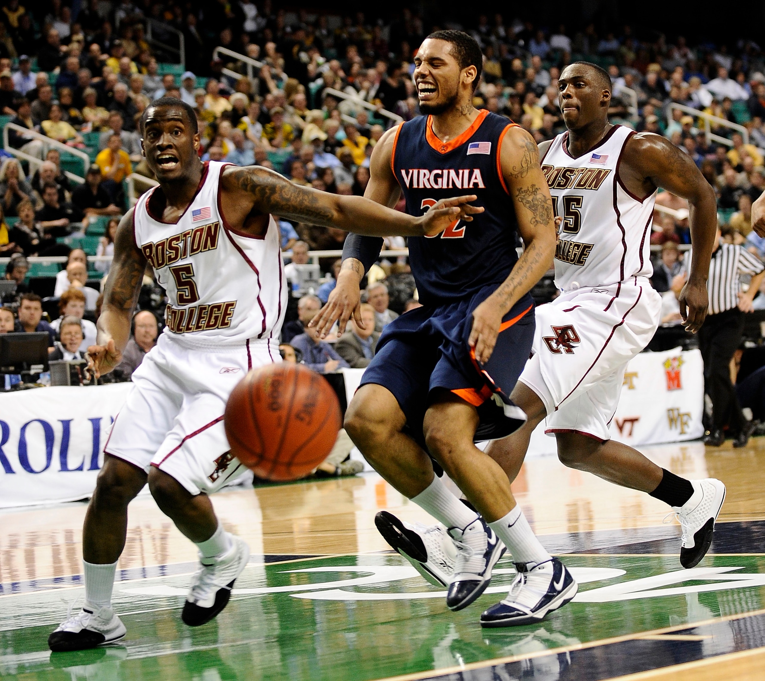 GREENSBORO, NC - MARCH 11:  Biko Paris #5 and Cortney Dunn #55 of the Boston College Eagles chase Mike Scott #32 of the University of Virginia Cavaliers in their first round game in the 2010 ACC Men's Basketball Tournament at the Greensboro Coliseum on Ma