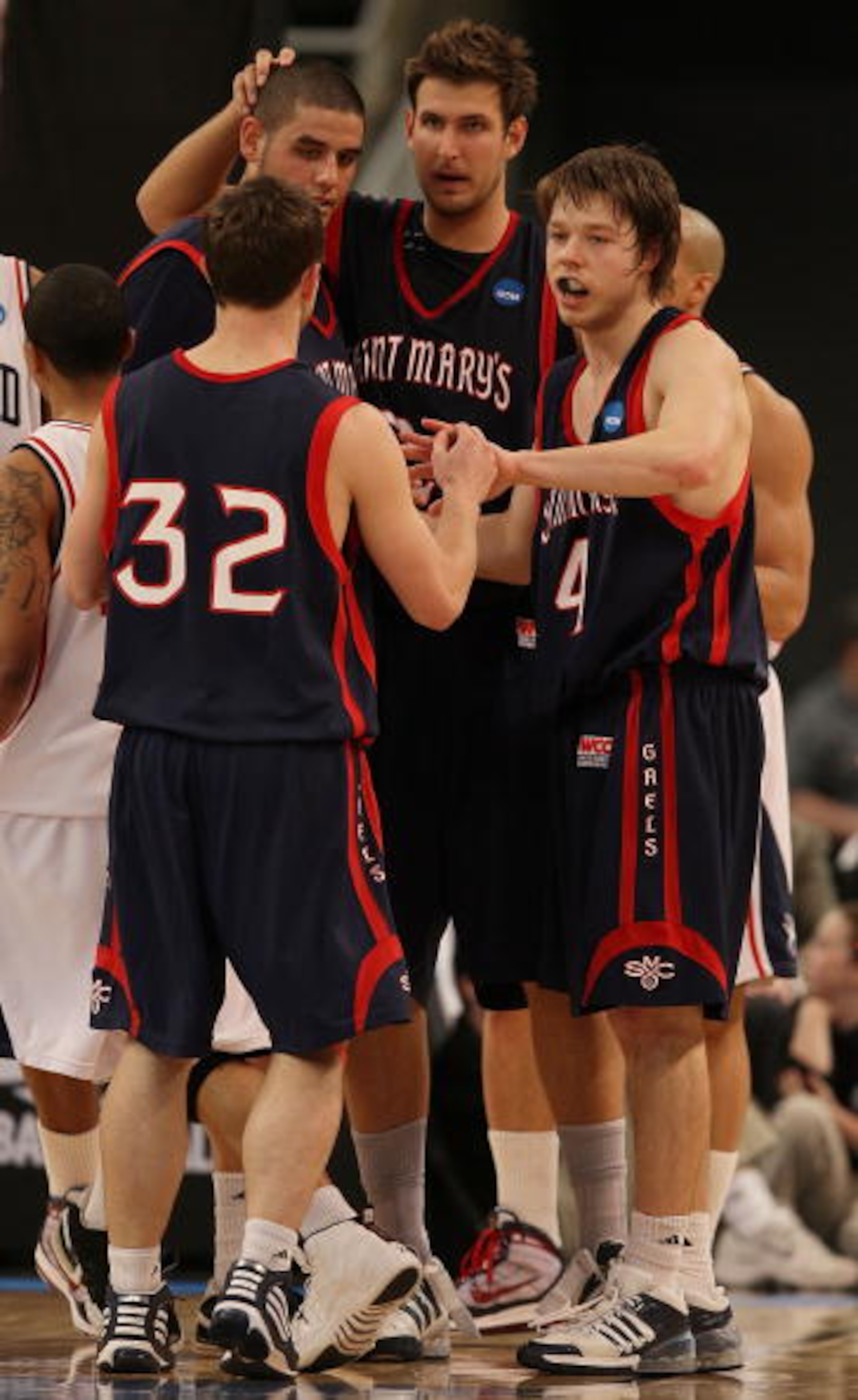 PROVIDENCE, RI - MARCH 18:  Ben Allen #21, Omar Samhan #50 and Matthew Dellavedova #4 of the Saint Mary's Gaels celebrate with Mickey McConnell #32 in the second half against the Richmond Spiders during the first round of the 2010 NCAA men's basketball to