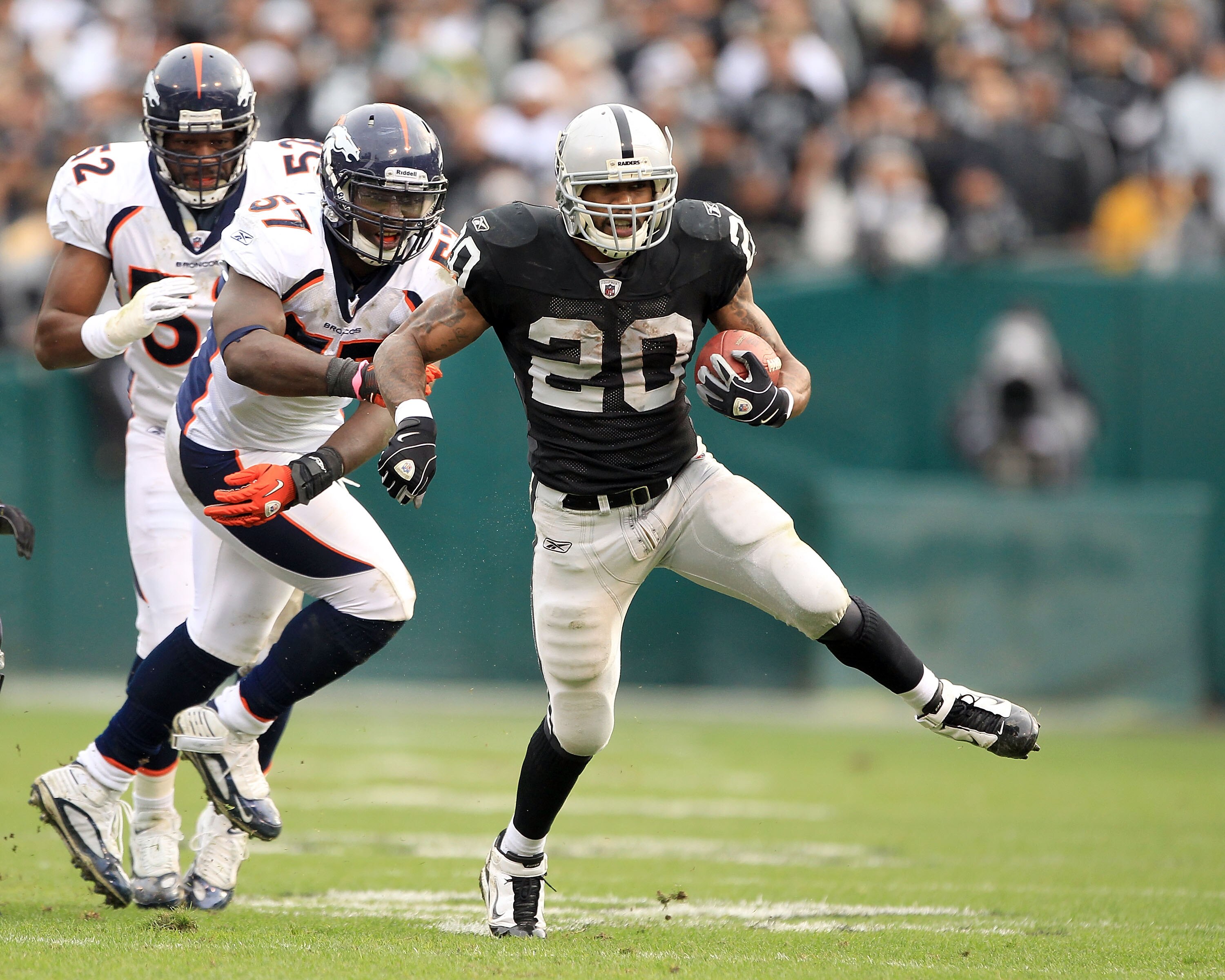 OAKLAND, CA - DECEMBER 19:  Darren McFadden #20 of the Oakland Raiders runs with the ball during their game against the Denver Broncos at Oakland-Alameda County Coliseum on December 19, 2010 in Oakland, California.  (Photo by Ezra Shaw/Getty Images)