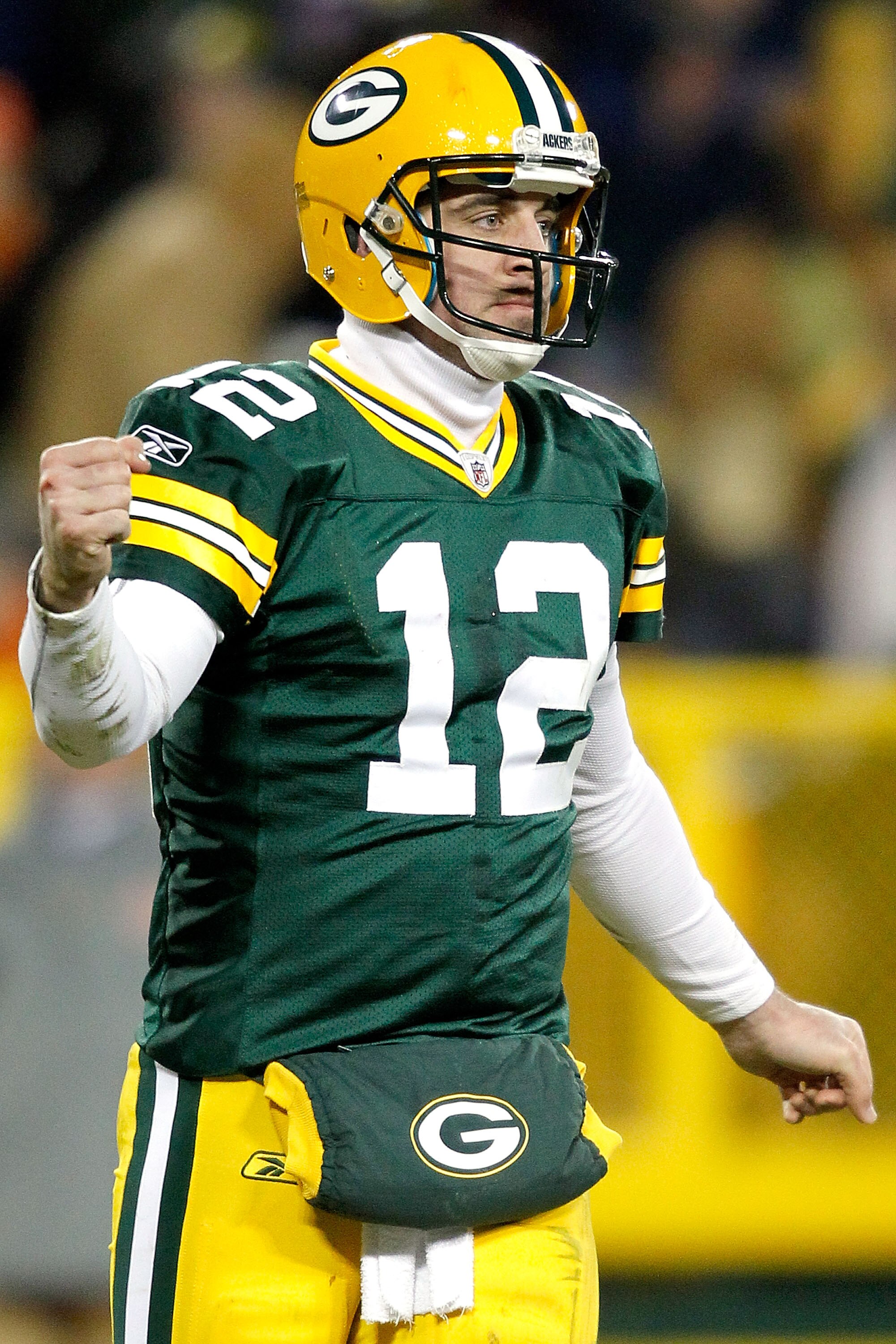 GREEN BAY, WI - JANUARY 02:  Quarterback Aaron Rodgers #12 of the Green Bay Packers celebrates a touchdown against the Chicago Bears at Lambeau Field on January 2, 2011 in Green Bay, Wisconsin.  (Photo by Matthew Stockman/Getty Images)
