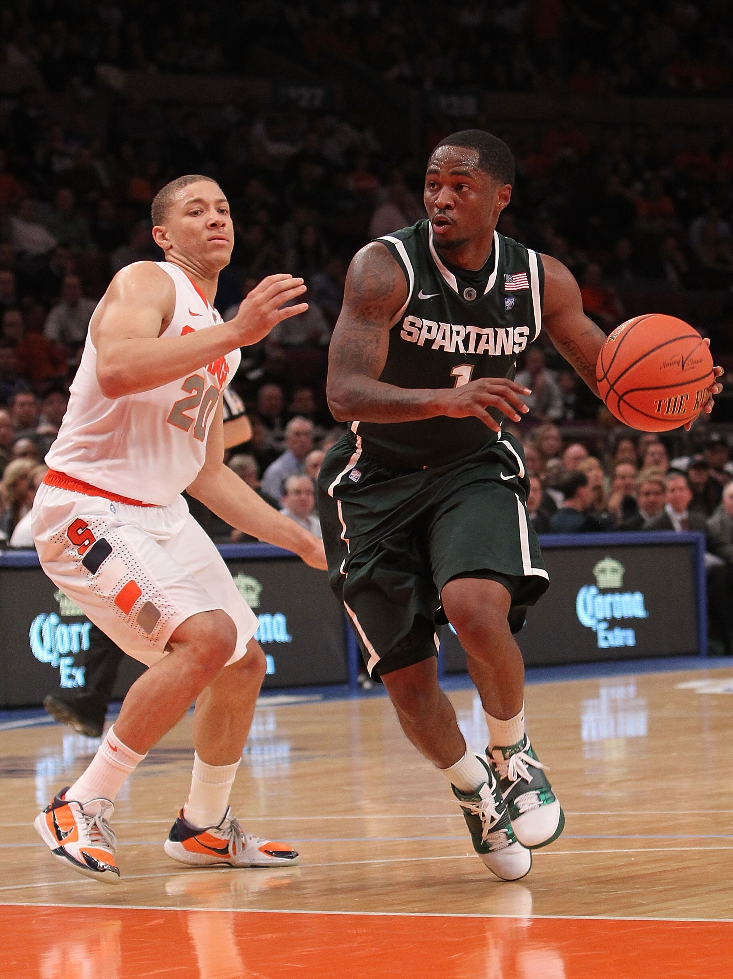 NEW YORK, NY - DECEMBER 07:  Kalin Lucas #1 of the Michigan Spartans drives to the basket alongside Brandon Triche #20 of the Syracuse Orange during their game at the Jimmy V Classic at Madison Square Garden on December 7, 2010 in New York City.  (Photo b