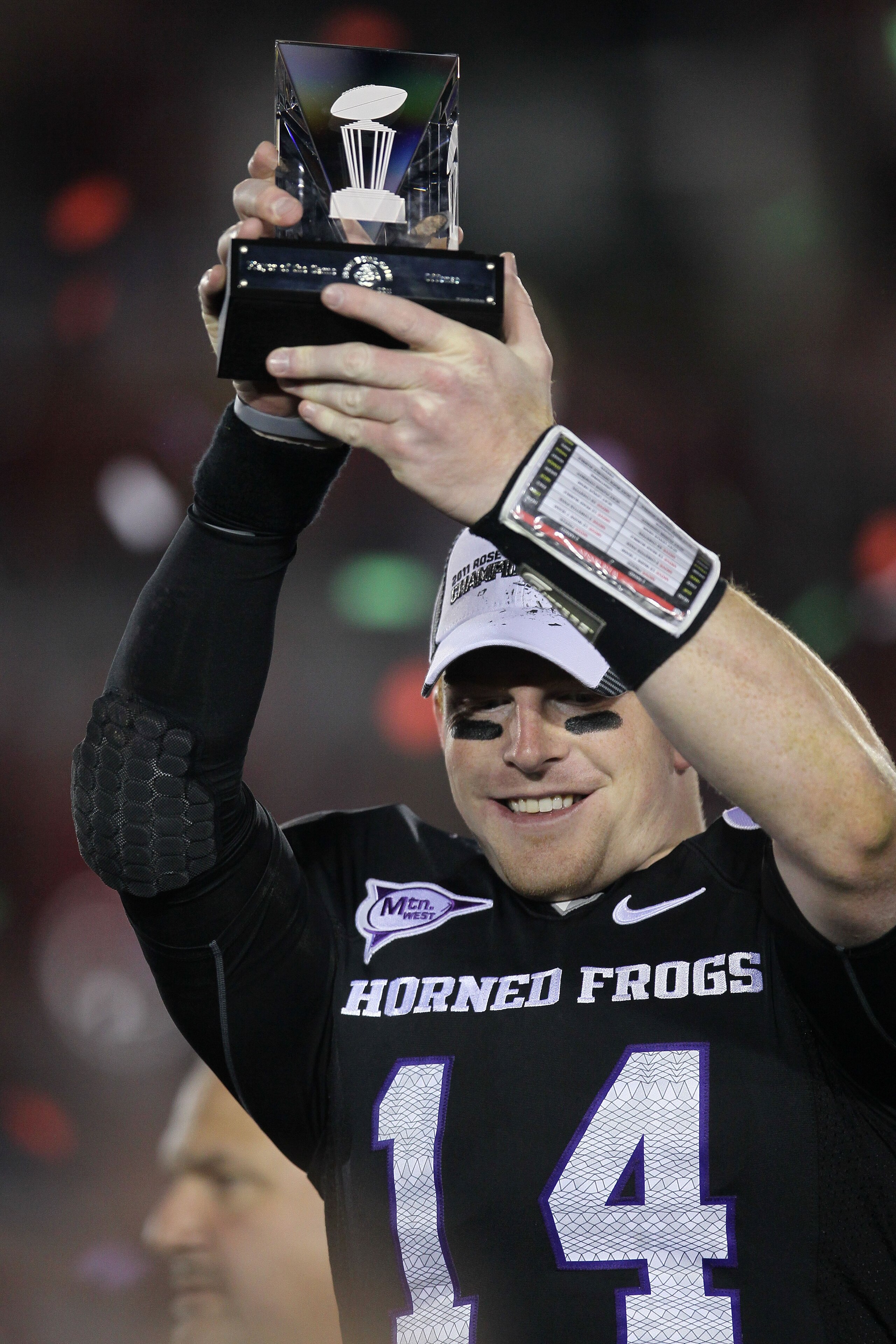 PASADENA, CA - JANUARY 01: Quarterback Andy Dalton #14 of the TCU Horned Frogs holds the offensive player of the game trophy after defeating the Wisconsin Badgers 21-19 in the 97th Rose Bowl game on January 1, 2011 in Pasadena, California. (Photo by Ste PASADENA, CA - JANUARY 01: Quarterback Andy Dalton #14 of the TCU Horned Frogs holds the offensive player of the game trophy after defeating the Wisconsin Badgers 21-19 in the 97th Rose Bowl game on January 1, 2011 in Pasadena, California. (Photo by Ste