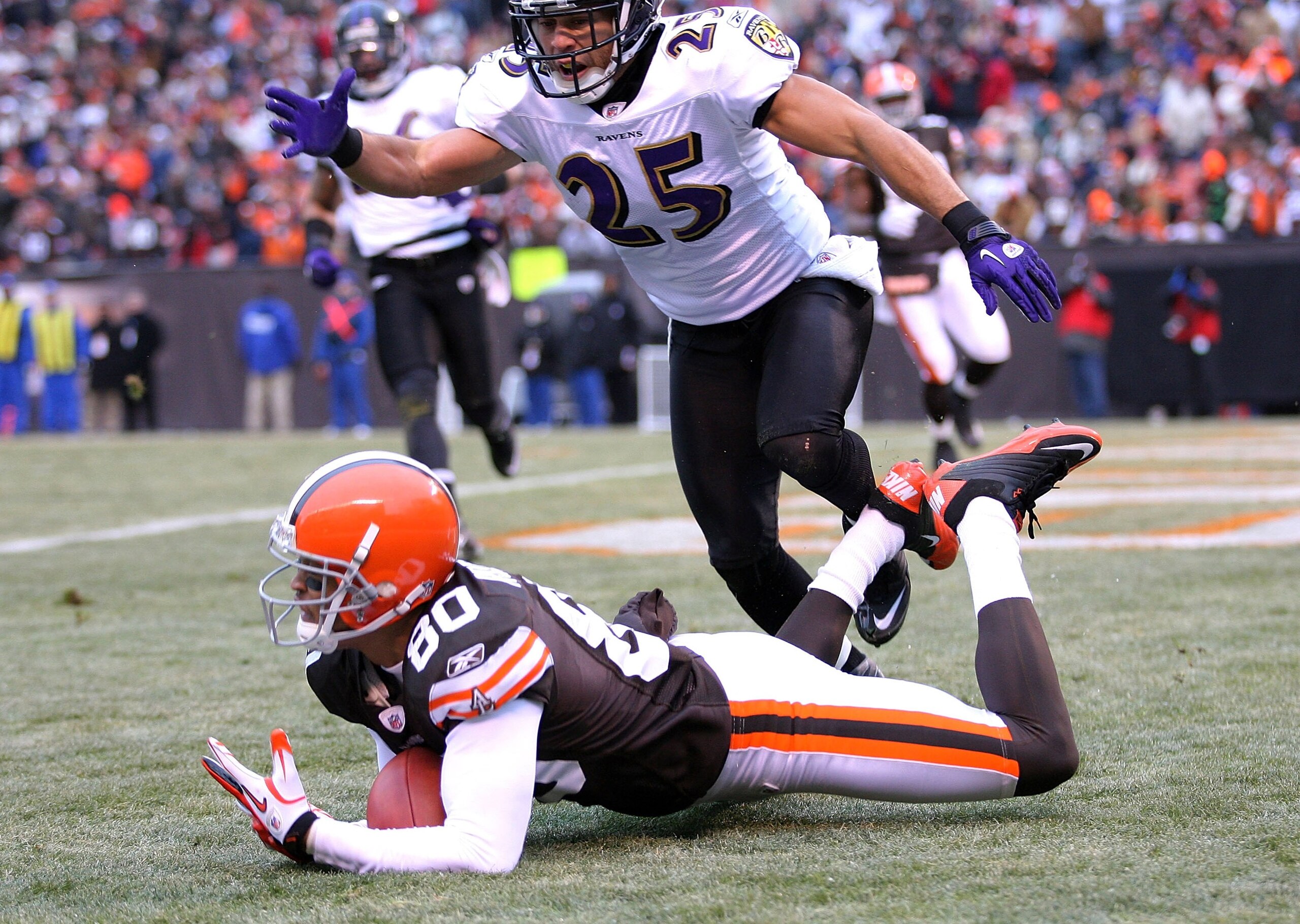CLEVELAND - DECEMBER 26:  Wide receiver Brian Robiskie, #80 of the Cleveland Browns scores a touchdown in front of cornerback Chris Carr, #25 of the Baltimore Ravens at Cleveland Browns Stadium on December 26, 2010 in Cleveland, Ohio.  (Photo by Matt Sull