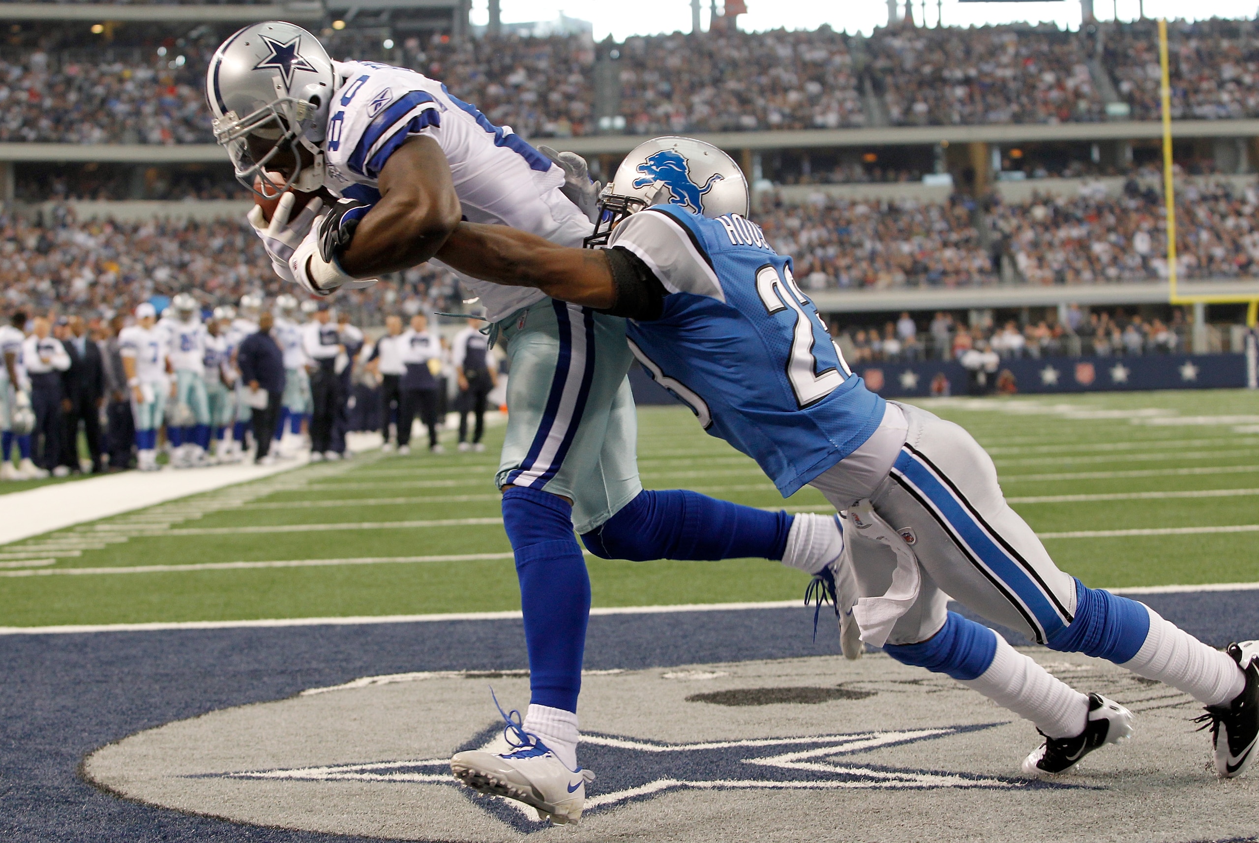 ARLINGTON, TX - NOVEMBER 21:  Dez Bryant #88 of the Dallas Cowboys scores against Chris Houston #23 of the Detroit Lions at Cowboys Stadium on November 21, 2010 in Arlington, Texas.  (Photo by Tom Pennington/Getty Images)