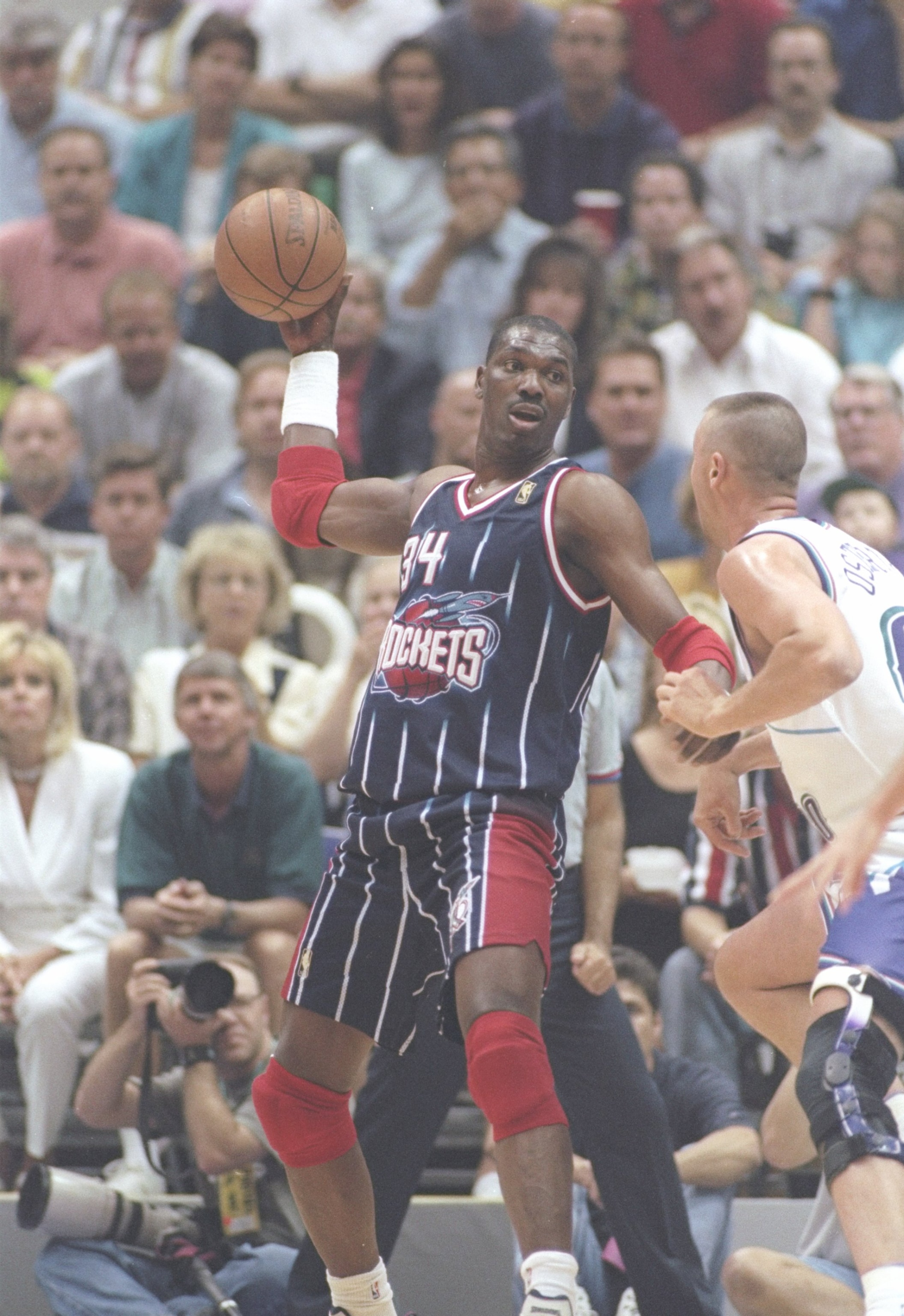 27 May 1997:  Center Hakeem Olajuwon of the Houston Rockets tries to fend off center Greg Ostertag of the Utah Jazz during a playoff game at the Delta Center in Salt Lake City, Utah.  The Jazz won the game 96-91. Mandatory Credit: Brian Bahr  /Allsport