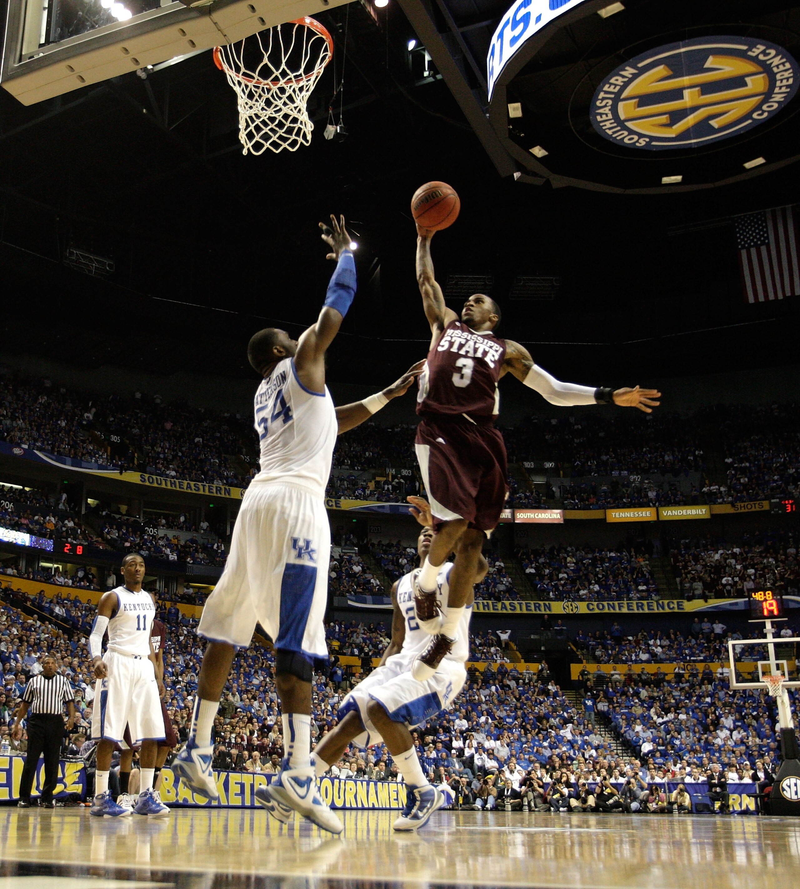 NASHVILLE, TN - MARCH 14:  Dee Bost #3 of the Mississippi State Bulldogs drives for a shot attempt against Patrick Patterson #54 of the Kentucky Wildcats during the final of the SEC Men's Basketball Tournament at the Bridgestone Arena on March 14, 2010 in