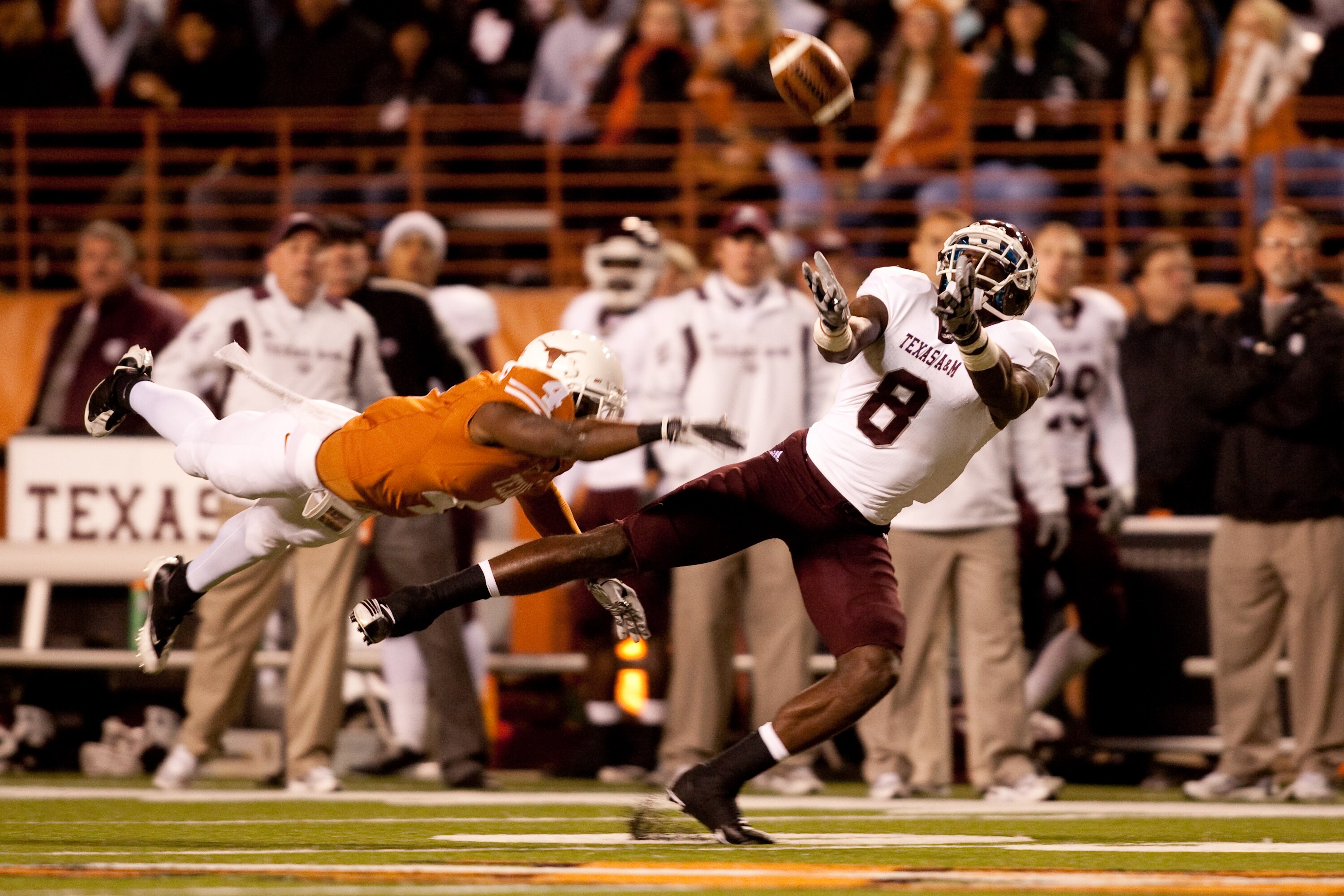 AUSTIN, TX - NOVEMBER 25:  Texas A&M wide receiver Jeff Fuller #8 misses a catch as University of Texas cornerback Aaron Williams #4 defends during the first half at Darrell K. Royal-Texas Memorial Stadium on November 25, 2010 in Austin, Texas. (Photo by 