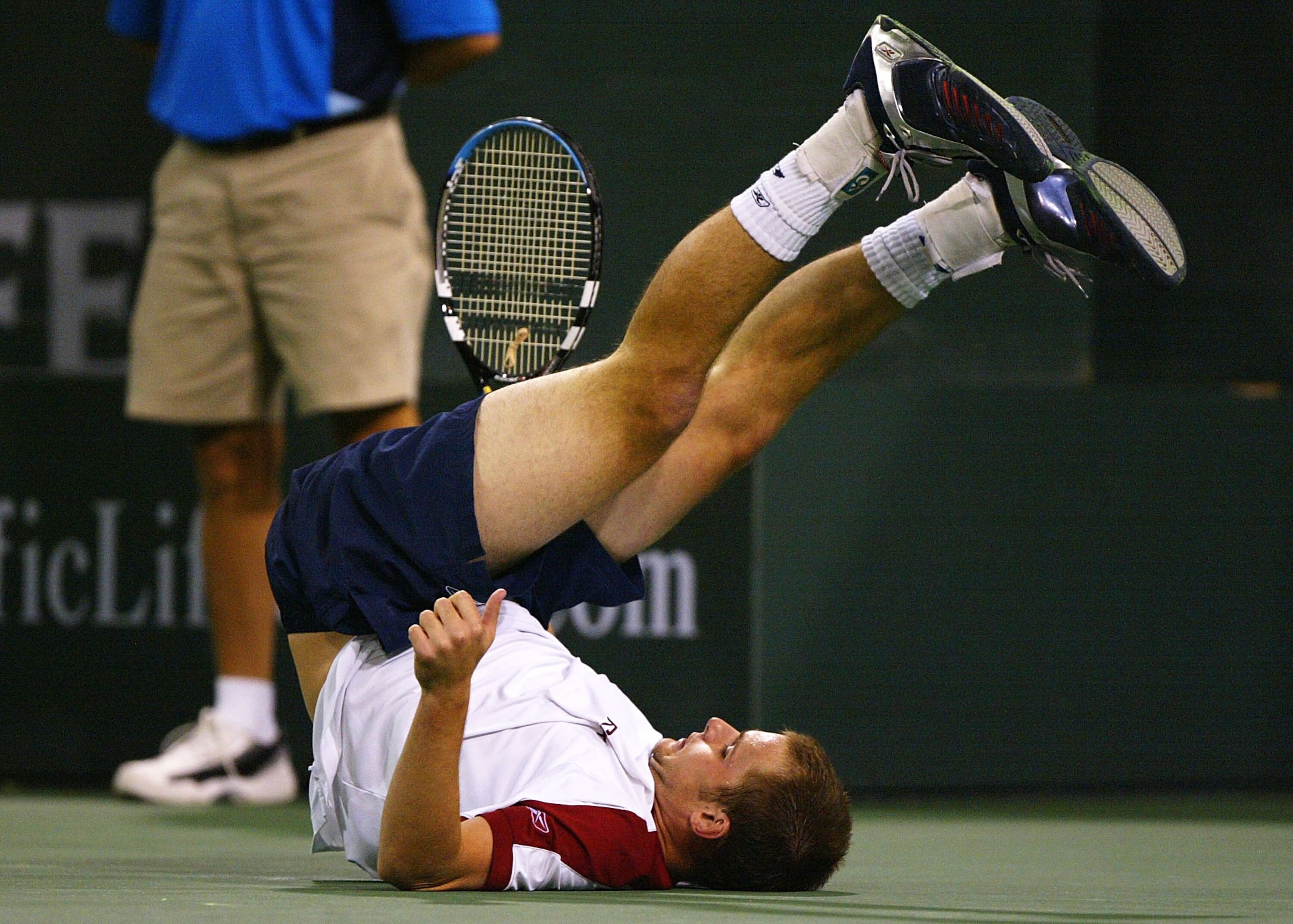 INDIAN WELLS, CA - MARCH 17:  Andy Roddick of the USA slips after running down a shot against Nicolas Escude of France at the Pacific Life Open on March 17, 2004 at the Indian Wells Tennis Garden in Indian Wells, California. (Photo by Jed Jacobsohn/Getty