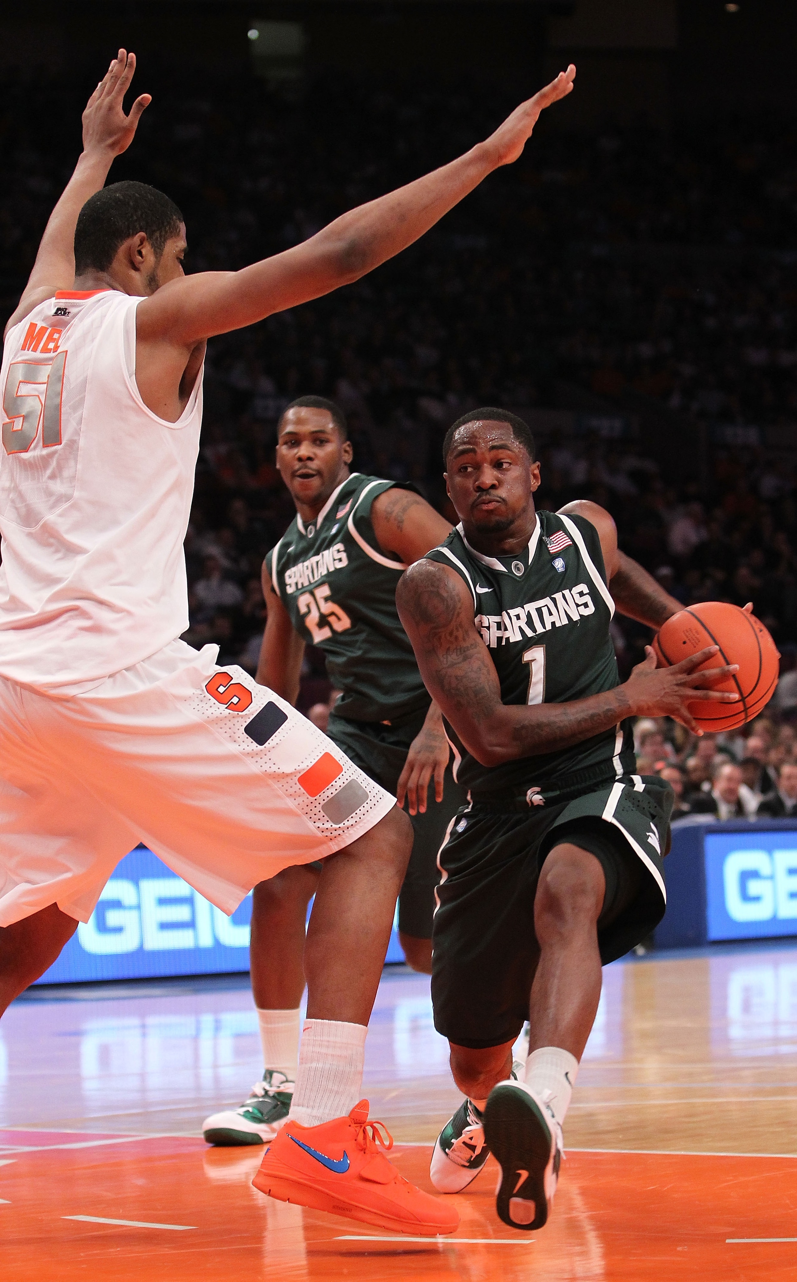 NEW YORK, NY - DECEMBER 07:  Kalin Lucas #1 of the Michigan Spartans goes to the basket against Fab Melo #51 of the Syracuse Orange during their game at the Jimmy V Classic at Madison Square Garden on December 7, 2010 in New York City.  (Photo by Nick Lah