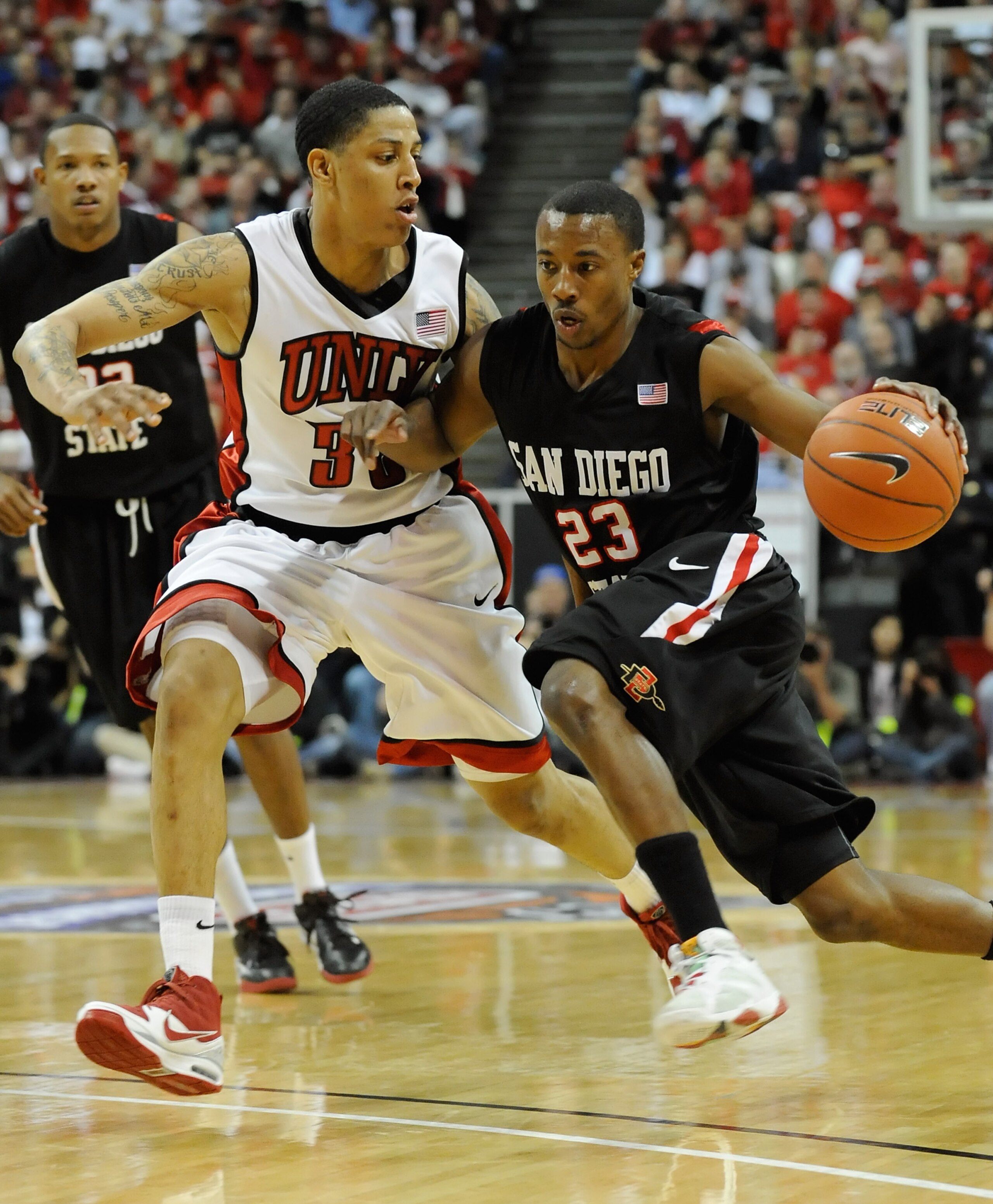 LAS VEGAS - MARCH 13:  D.J. Gay #23 of the San Diego State Aztecs drives against Tre'Von Willis #33 of the UNLV Rebels during the championship game of the Conoco Mountain West Conference Basketball tournament at the Thomas & Mack Center March 13, 2010 in