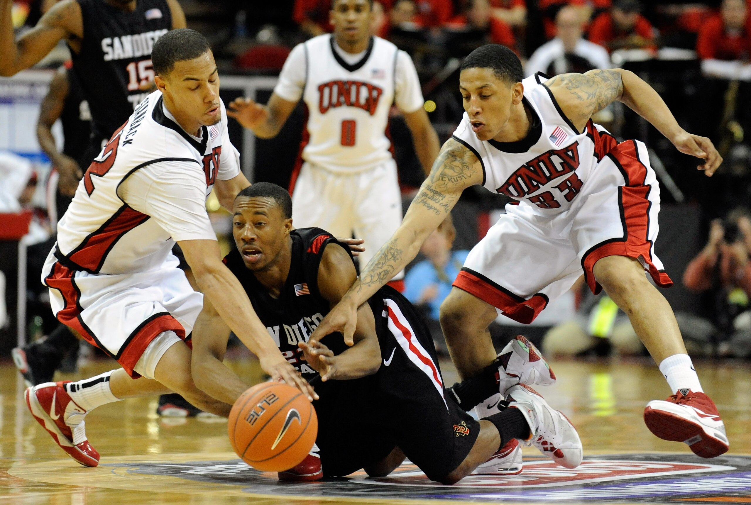 LAS VEGAS - MARCH 13:  D.J. Gay #23 of the San Diego State Aztecs loses the ball under pressure from Chace Stanback #22 and Tre'Von Willis #33 of the UNLV Rebels during the championship game of the Conoco Mountain West Conference Basketball tournament at