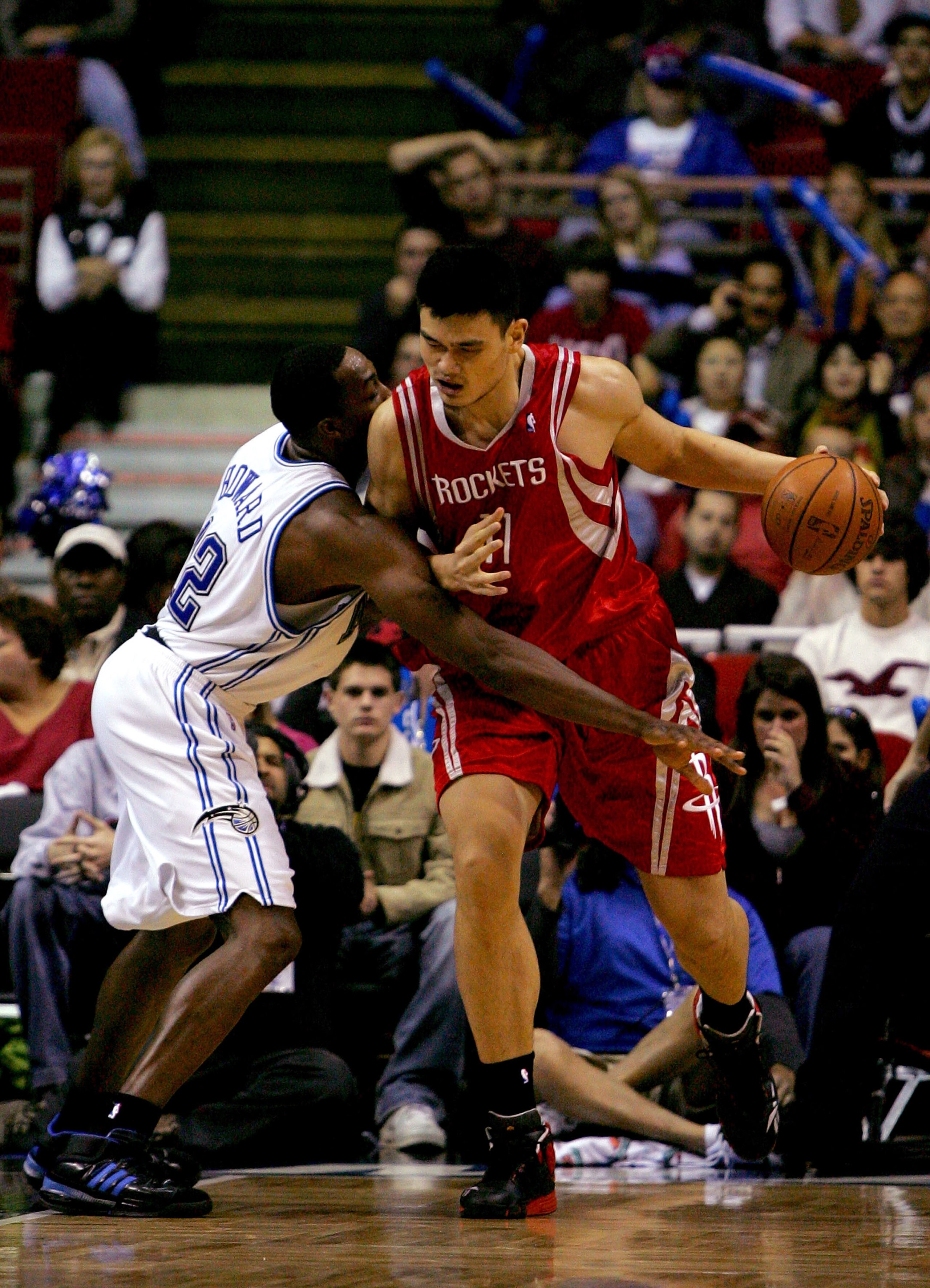 ORLANDO, FL - JANUARY 4: Yao Ming #11 of the Houston Rockets drives against Dwight Howard #12 of the Orlando Magic at Amway Arena January 4, 2008 in Orlando Florida. NOTE TO USER: User expressly acknowledges and agrees that, by downloading and or using th