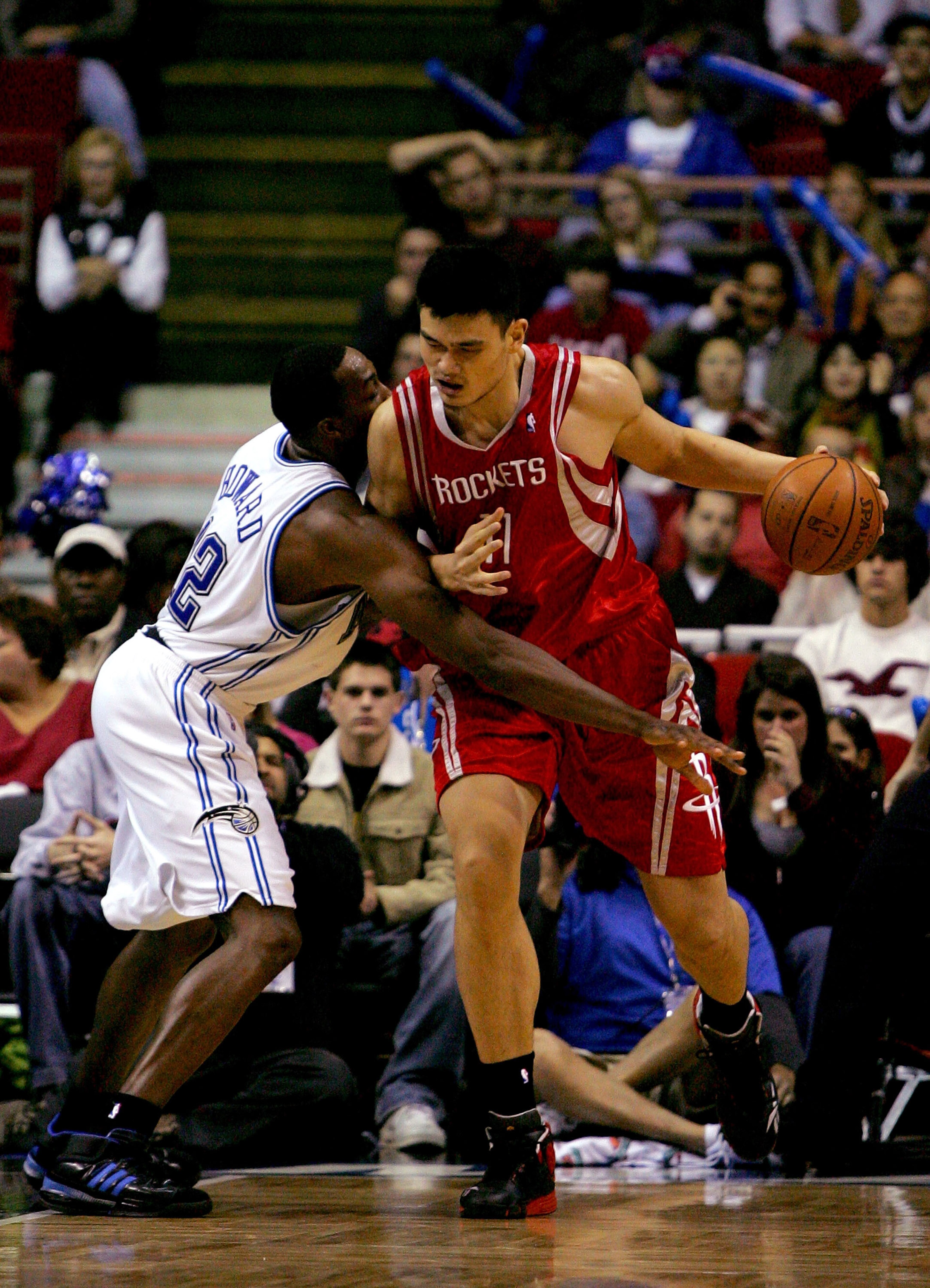 ORLANDO, FL - JANUARY 4: Yao Ming #11 of the Houston Rockets drives against Dwight Howard #12 of the Orlando Magic at Amway Arena January 4, 2008 in Orlando Florida. NOTE TO USER: User expressly acknowledges and agrees that, by downloading and or using th
